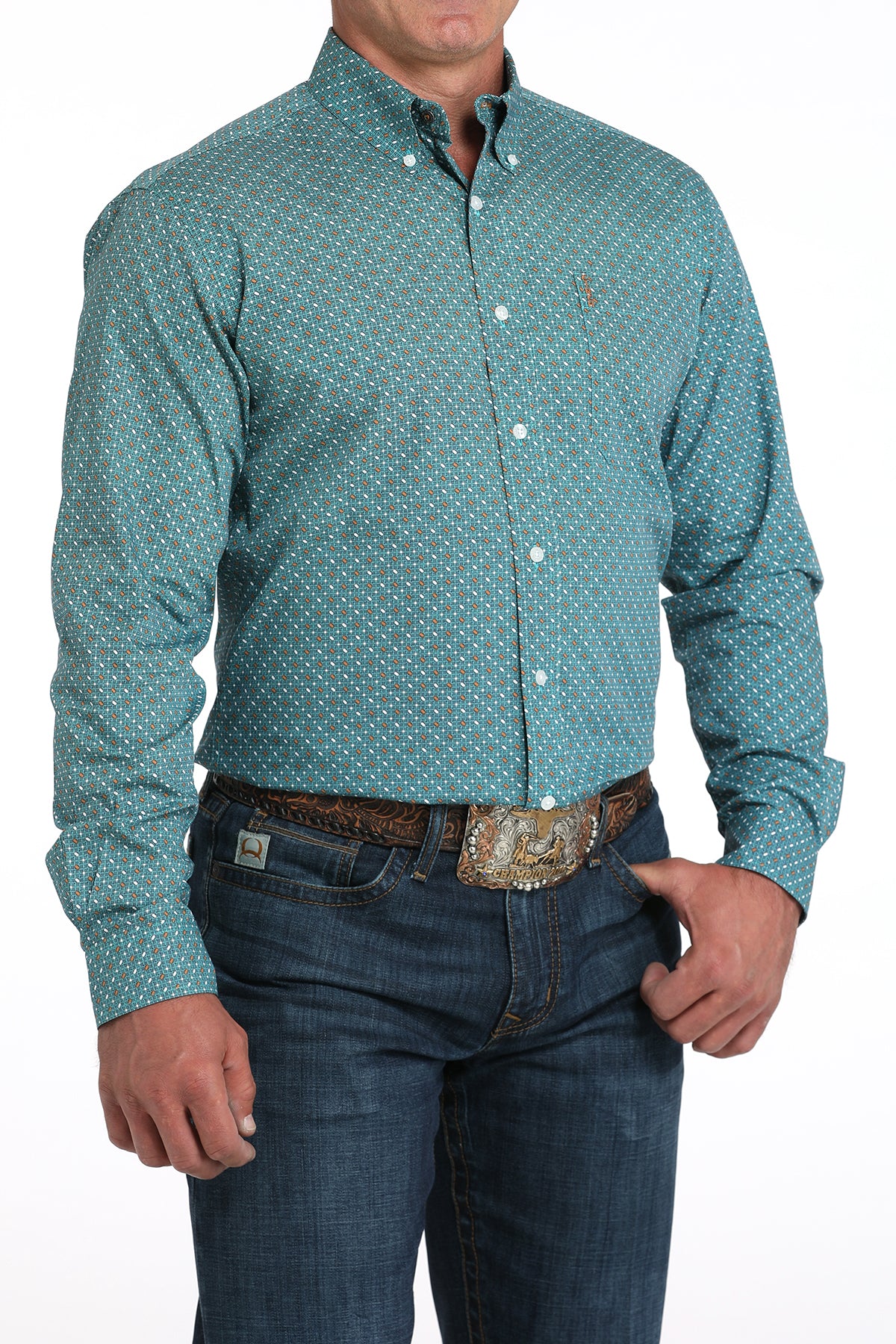 Man wearing a teal long sleeve button-down with jeans and a belt