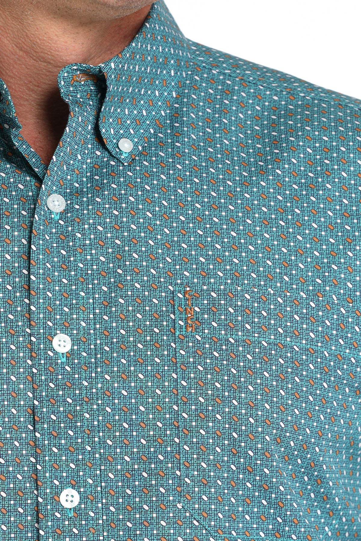 Close-up of a man wearing a teal long sleeve button-down