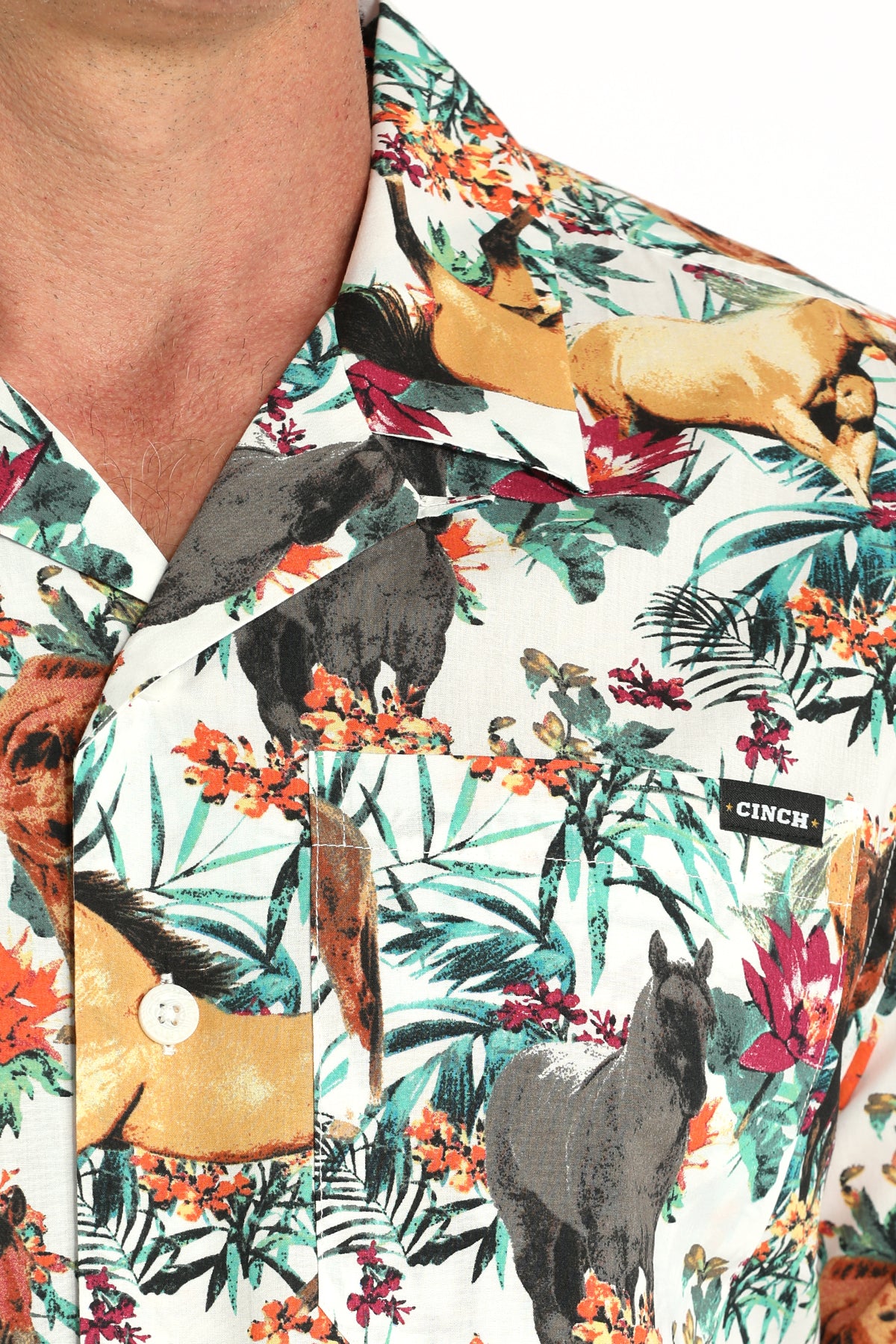 Close-up of a man wearing a floral shirt with animals on it