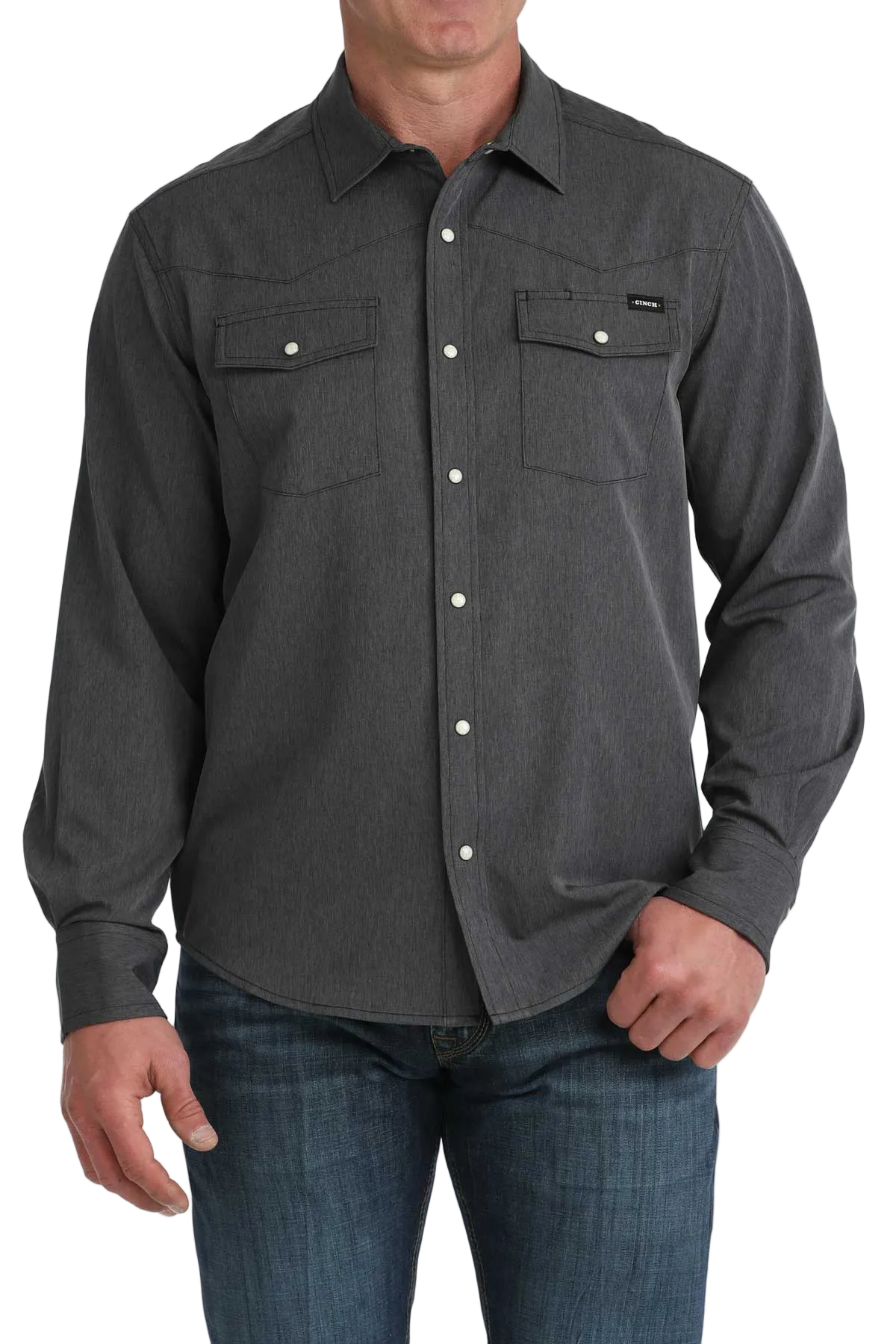 Man wearing a dark gray button-up shirt with a white background