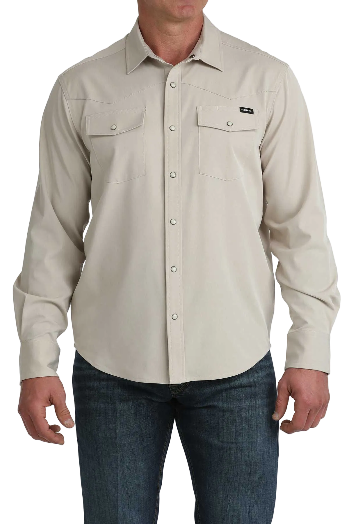 Beige button-up shirt worn by a person on a white background