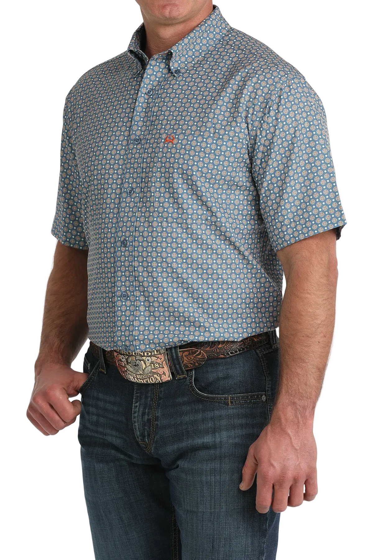 Man wearing a patterned short-sleeve shirt and jeans on a white background