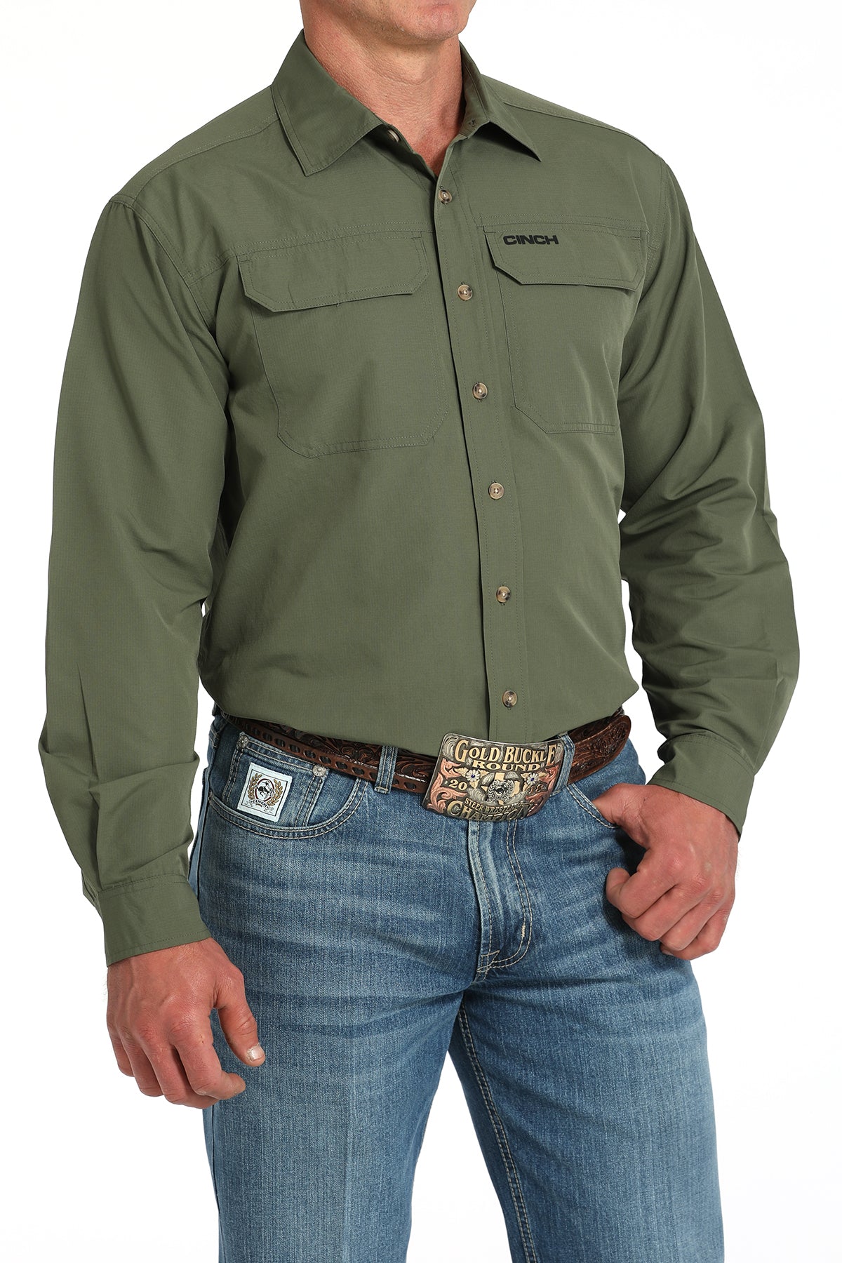 Green work shirt with 'Cinch' branding worn by a person on a white background