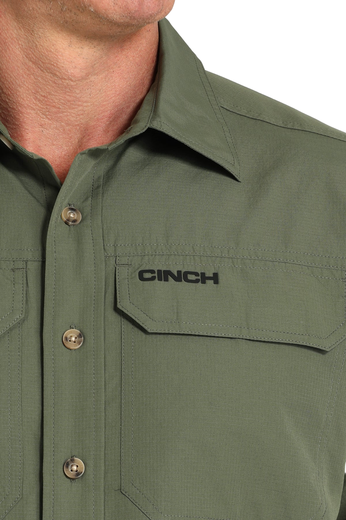 Close-up of a man wearing a green long sleeve button-down shirt on a transparent background