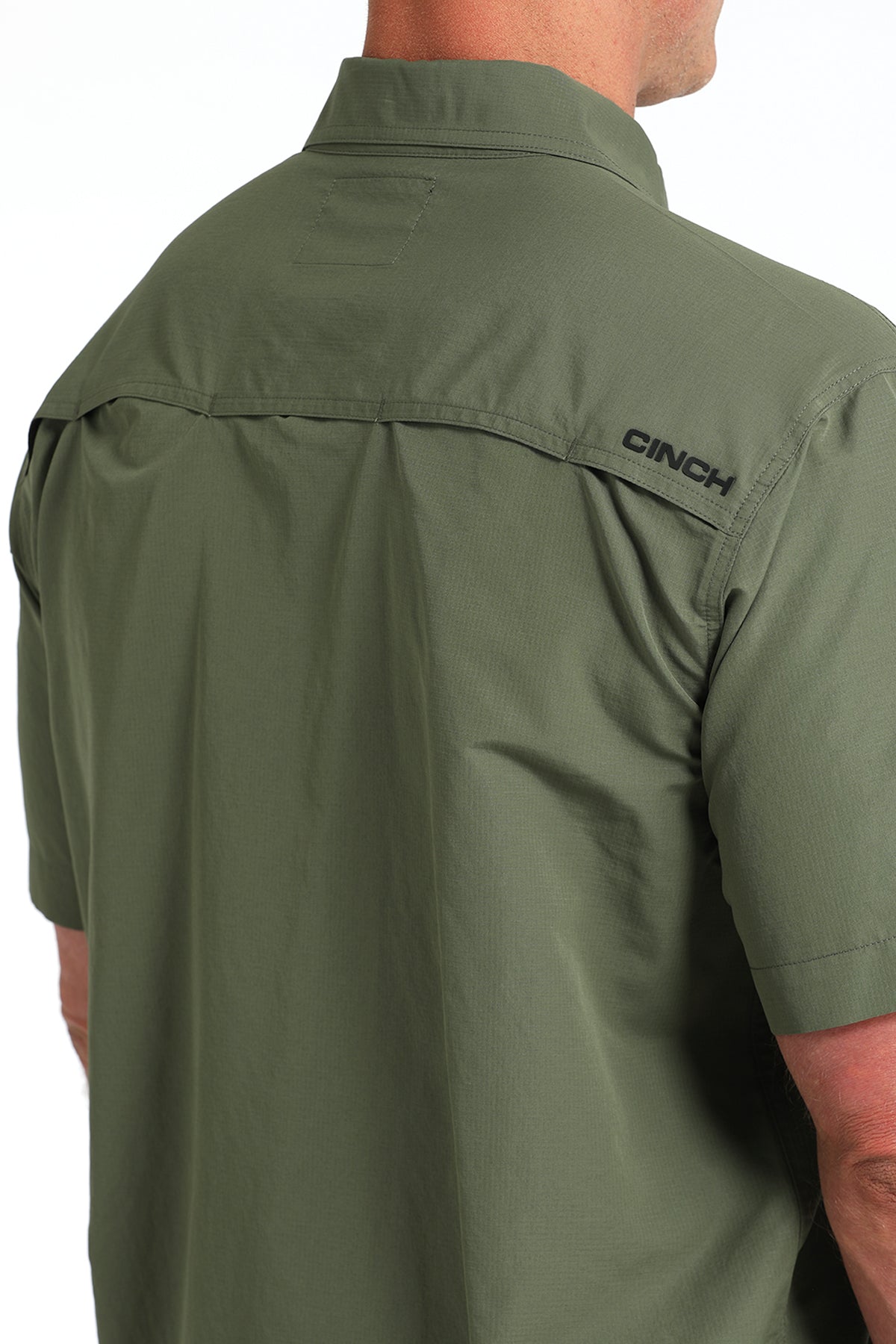 Green shirt with 'CINCH' branding on the back