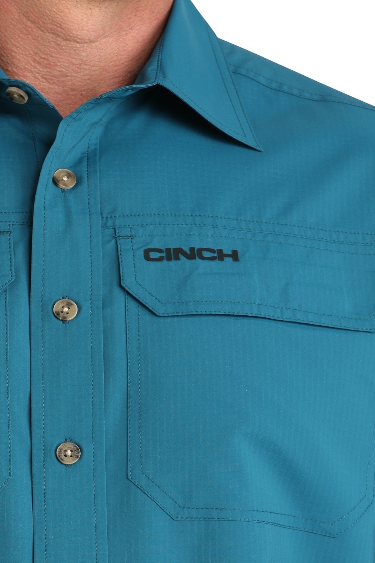 Go West Supply Men's teal poly-spandex short sleeve button-down shirt with embroidered Cinch logo and dual chest pockets.