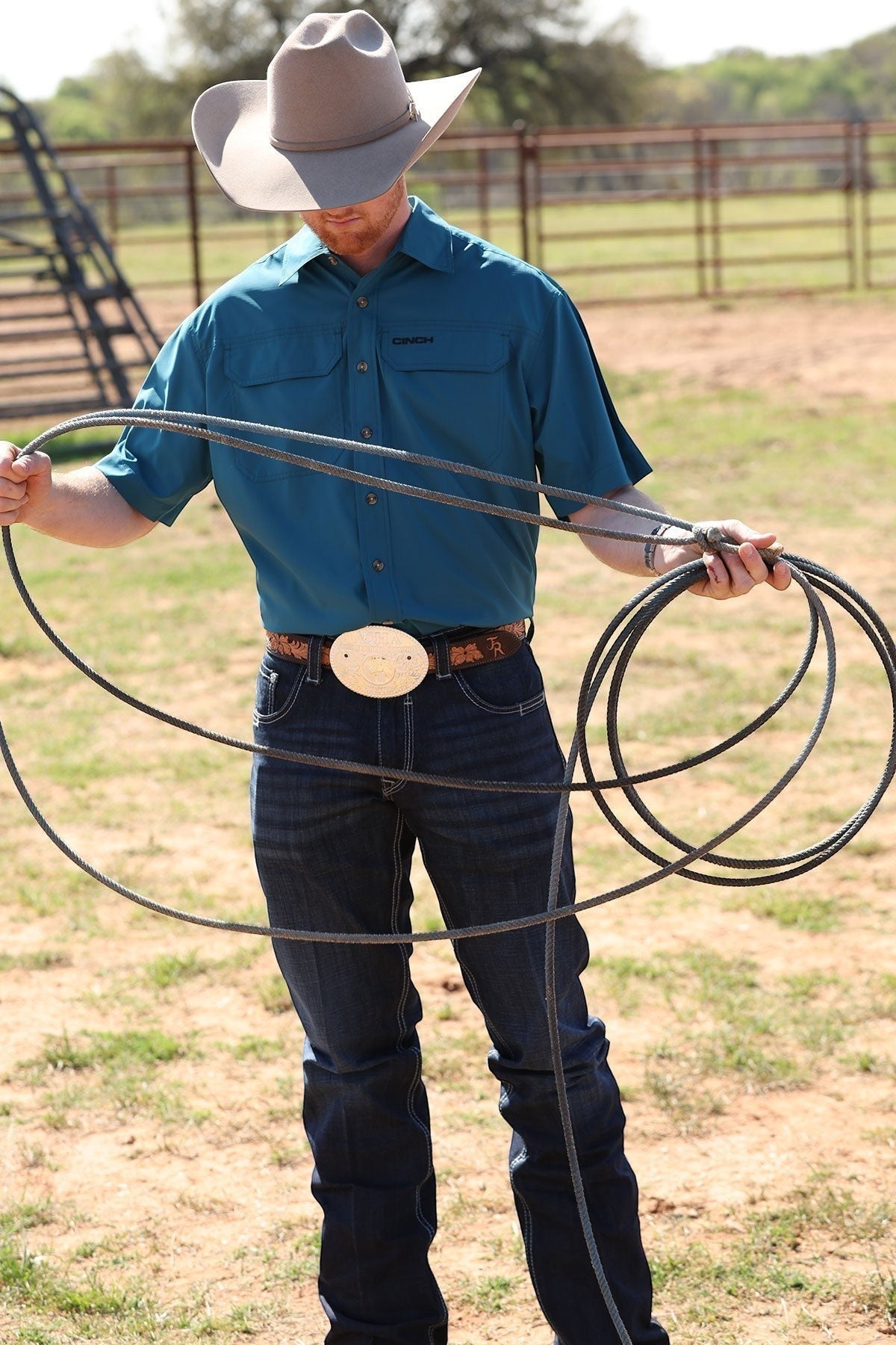 Go West Supply men's teal short-sleeve Arenaflex shirt with embroidered logo and two chest pockets.