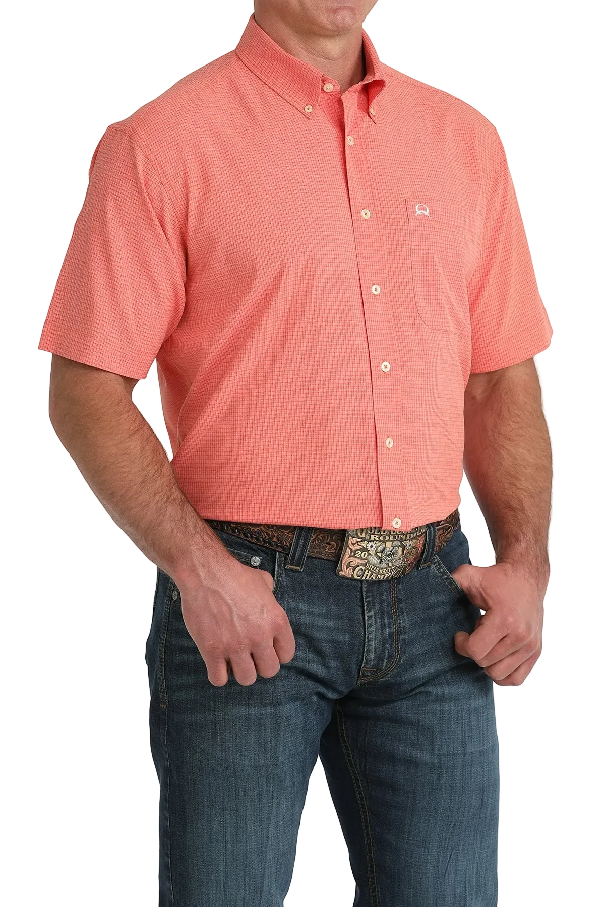 Man wearing a coral short-sleeve shirt and blue jeans on a white background