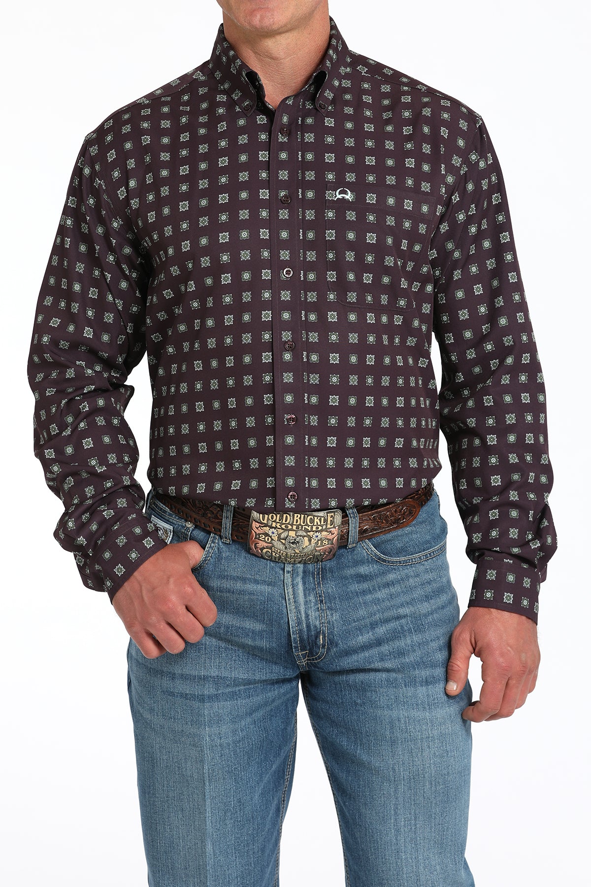 Man wearing a purple long sleeve button-down shirt with jeans and a belt