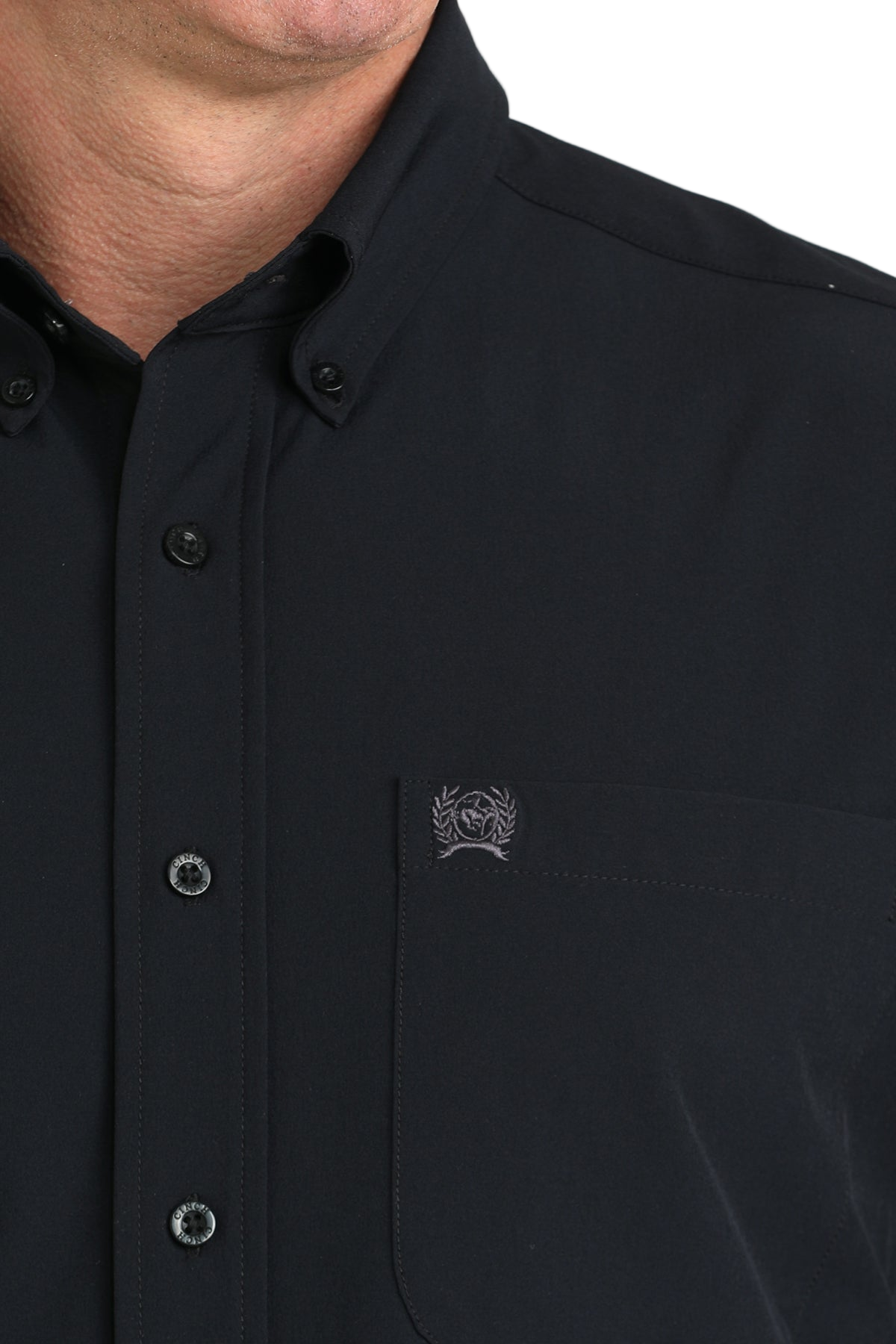 Close-up of a man wearing a black long sleeve button-down shirt on a transparent background