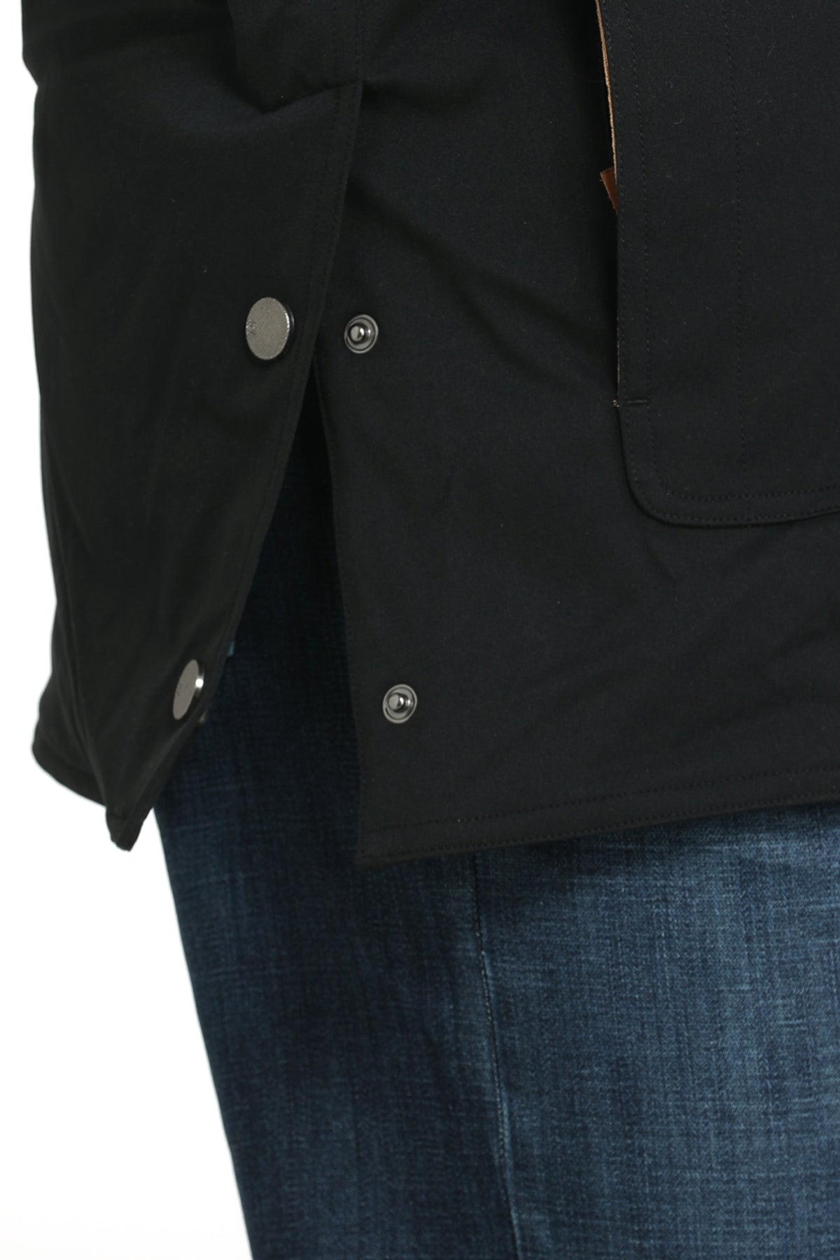 Close-up, side detail of a man wearing a black jacket and jeans on a white background