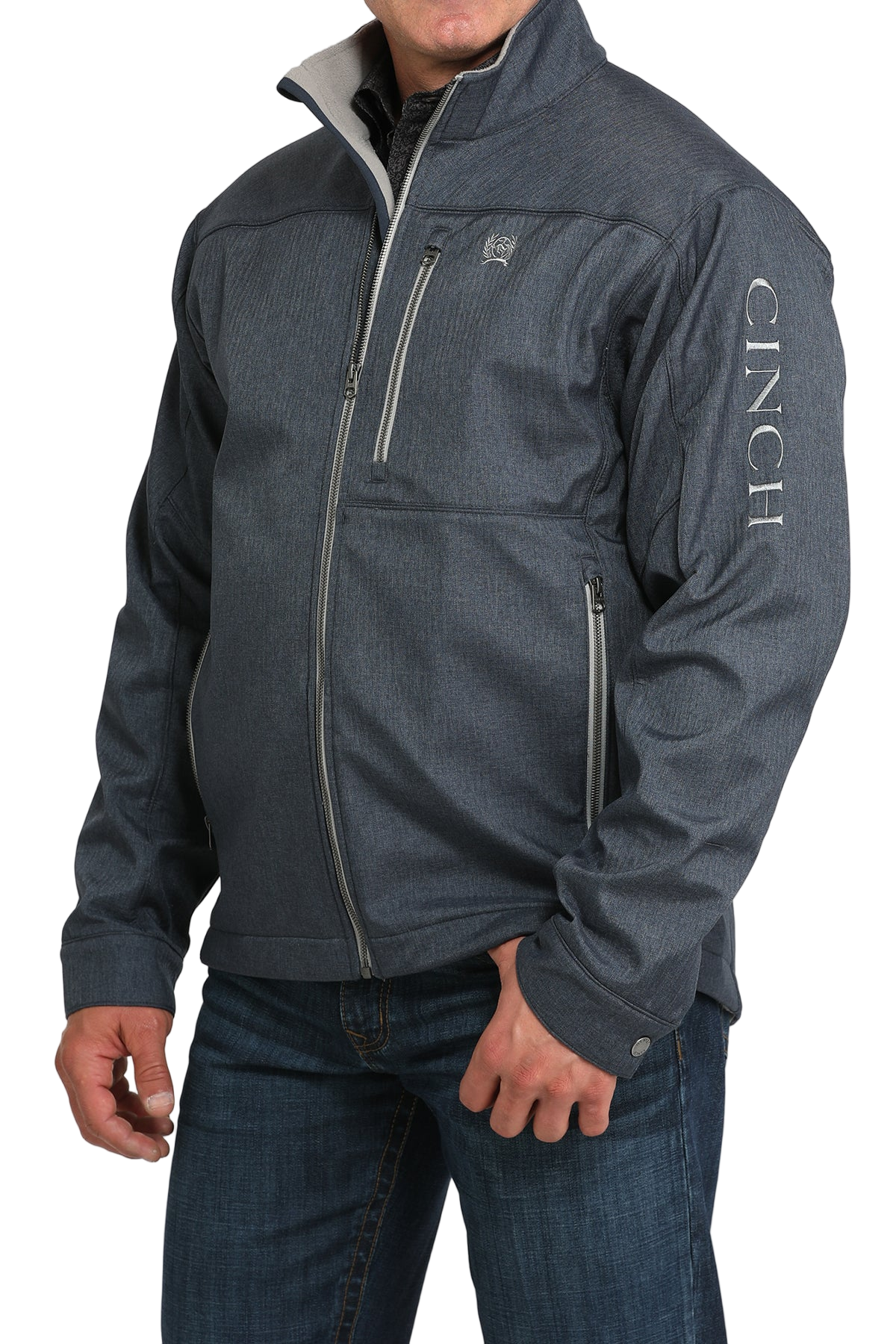 Man wearing a blue zip-front jacket, paired with dark jeans