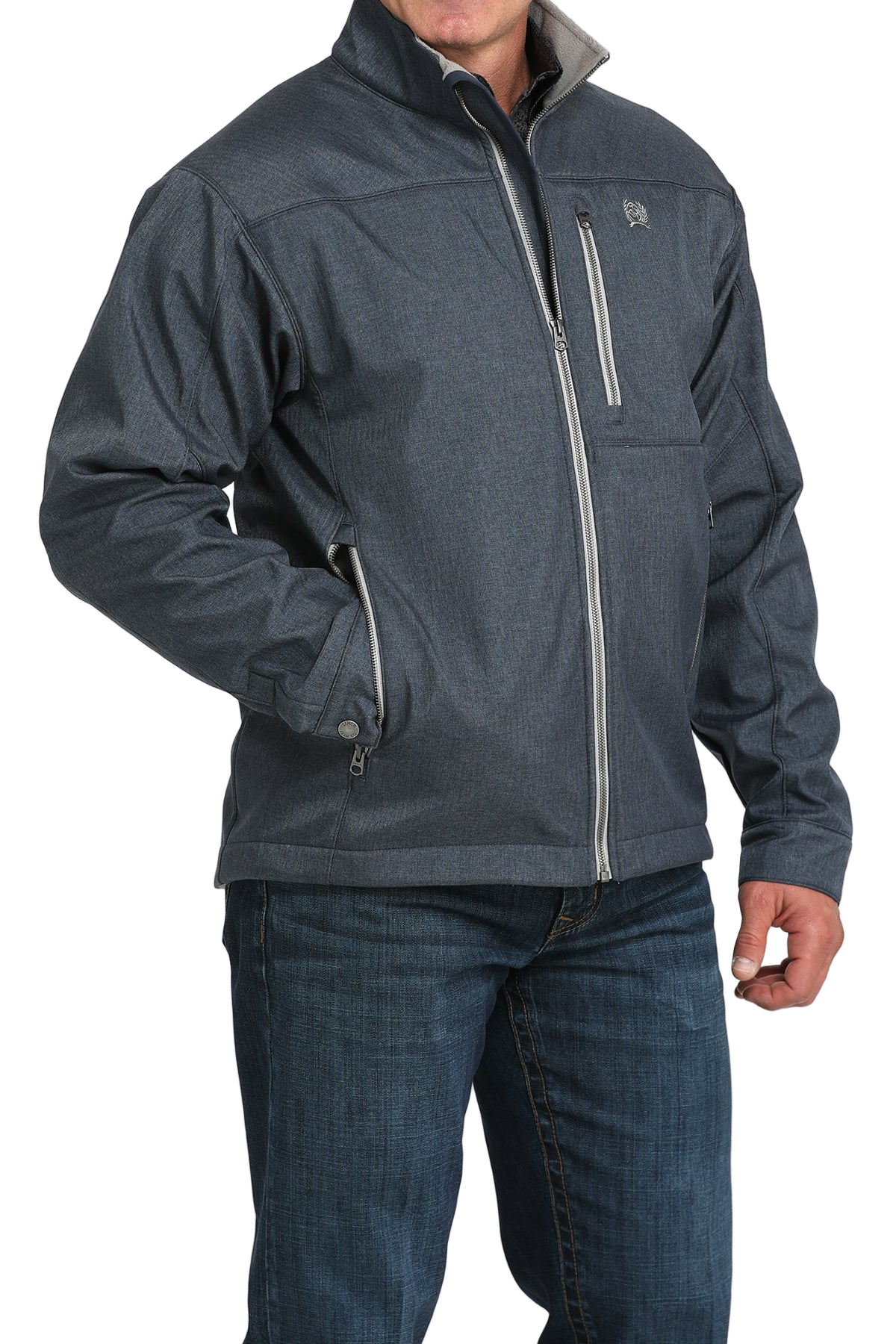 Man wearing a blue zip-front jacket, paired with dark jeans