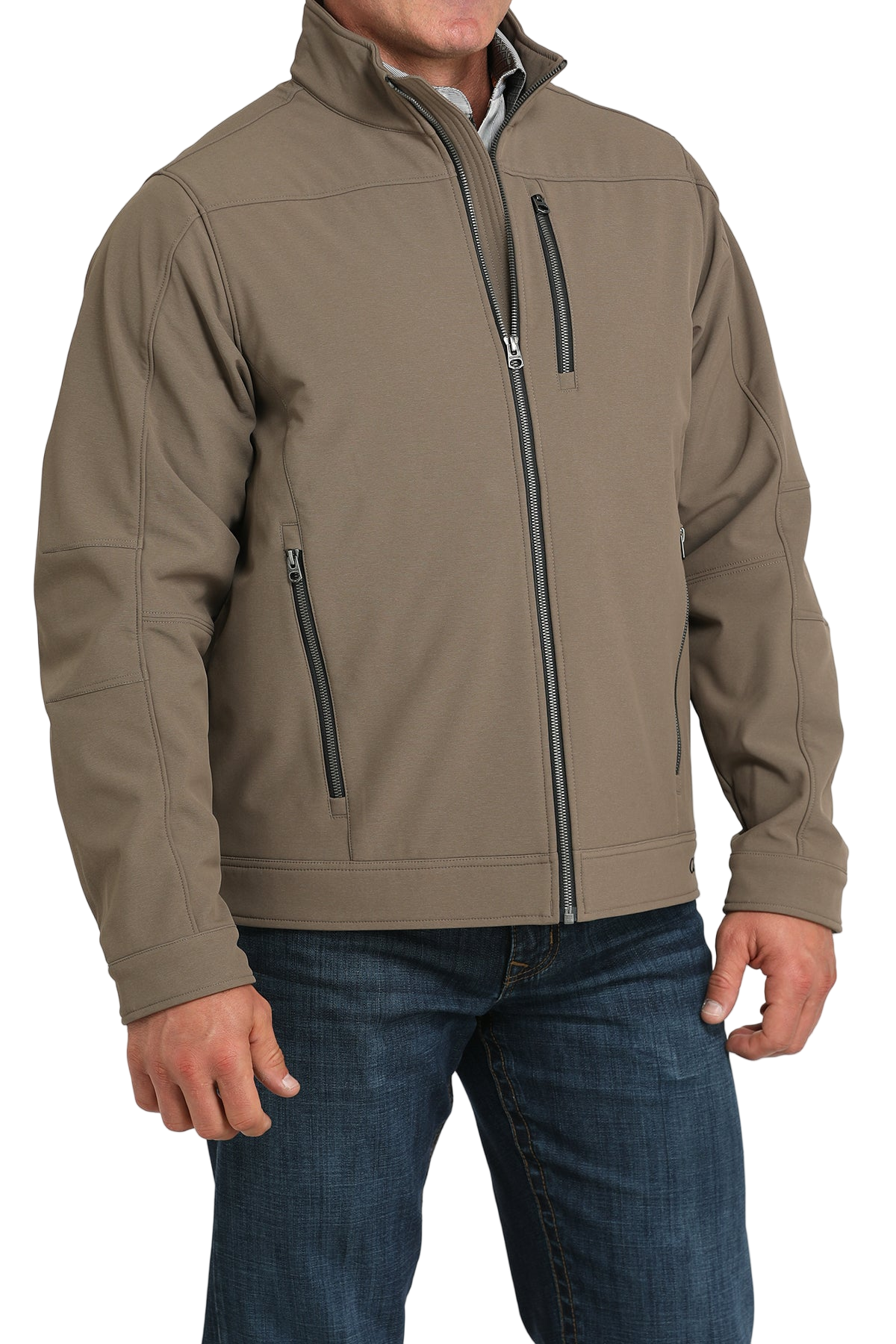 Man wearing a tan zip-front jacket, paired with dark jeans