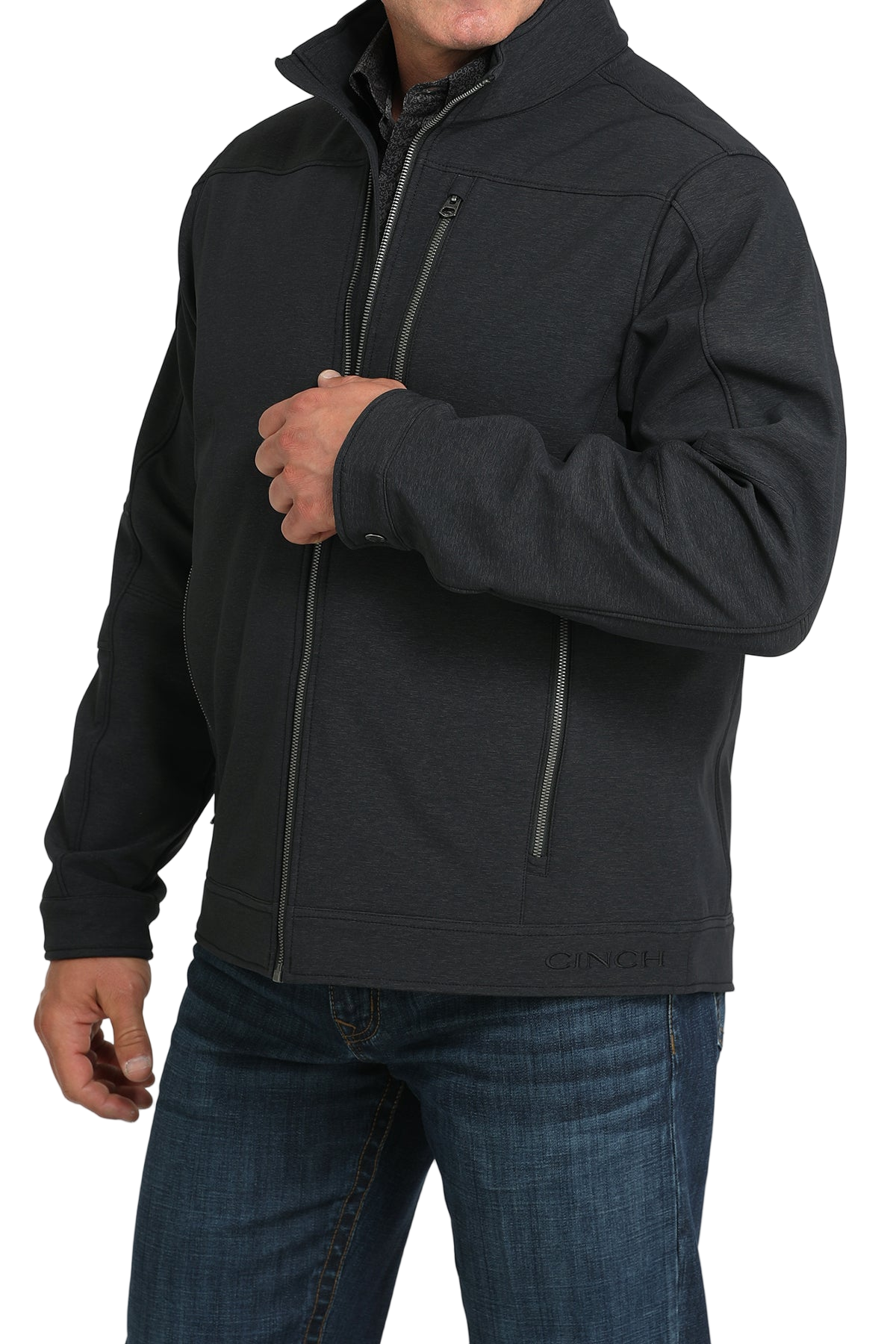 Man wearing a black zip-front jacket, paired with dark jeans