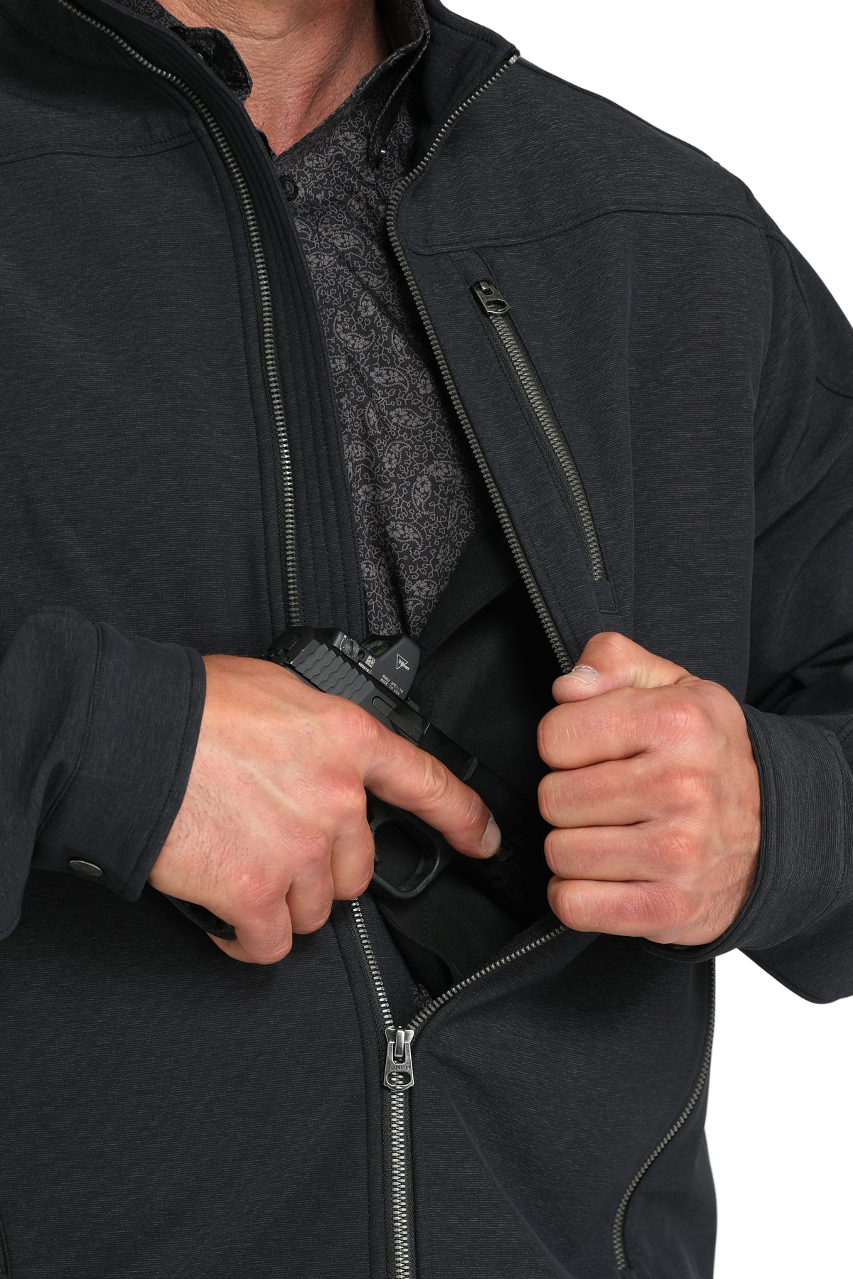 Man wearing a black jacket, shown partially unzipped to reveal an interior concealed-carry pocket