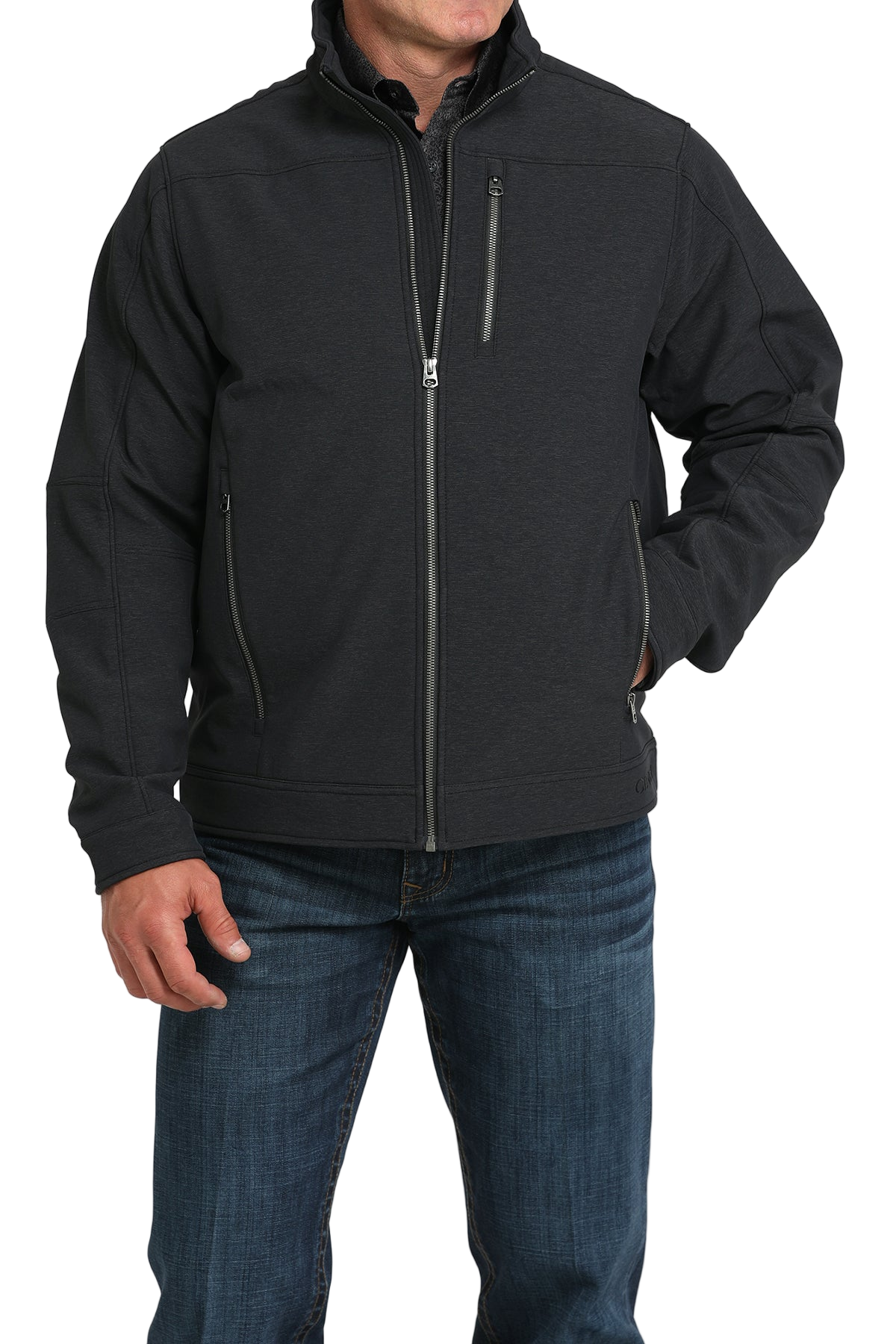 Man wearing a black zip-front jacket, paired with dark jeans