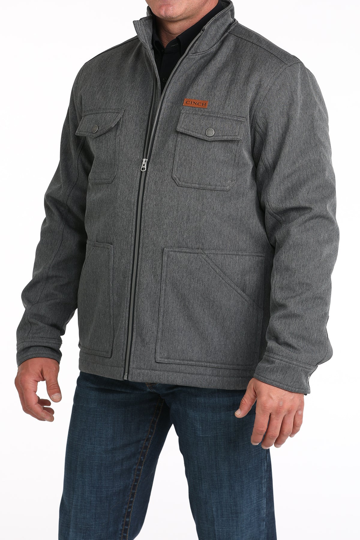Man wearing a gray jacket and jeans on a white background