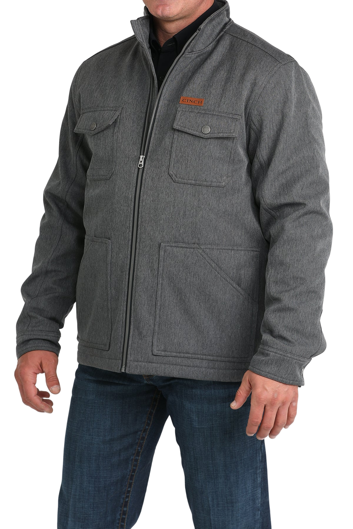 Man wearing a gray zip-front jacket, paired with dark jeans