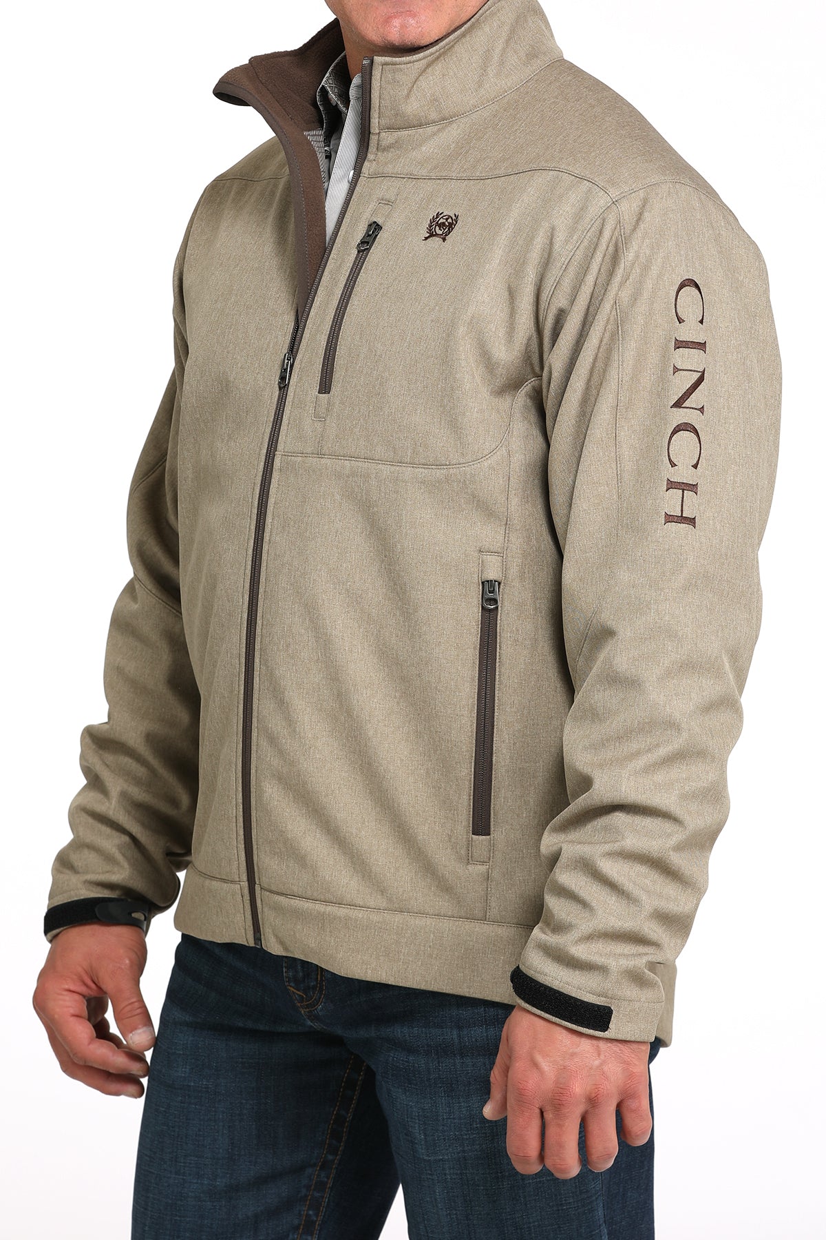 Man wearing a khaki jacket and jeans on a white background