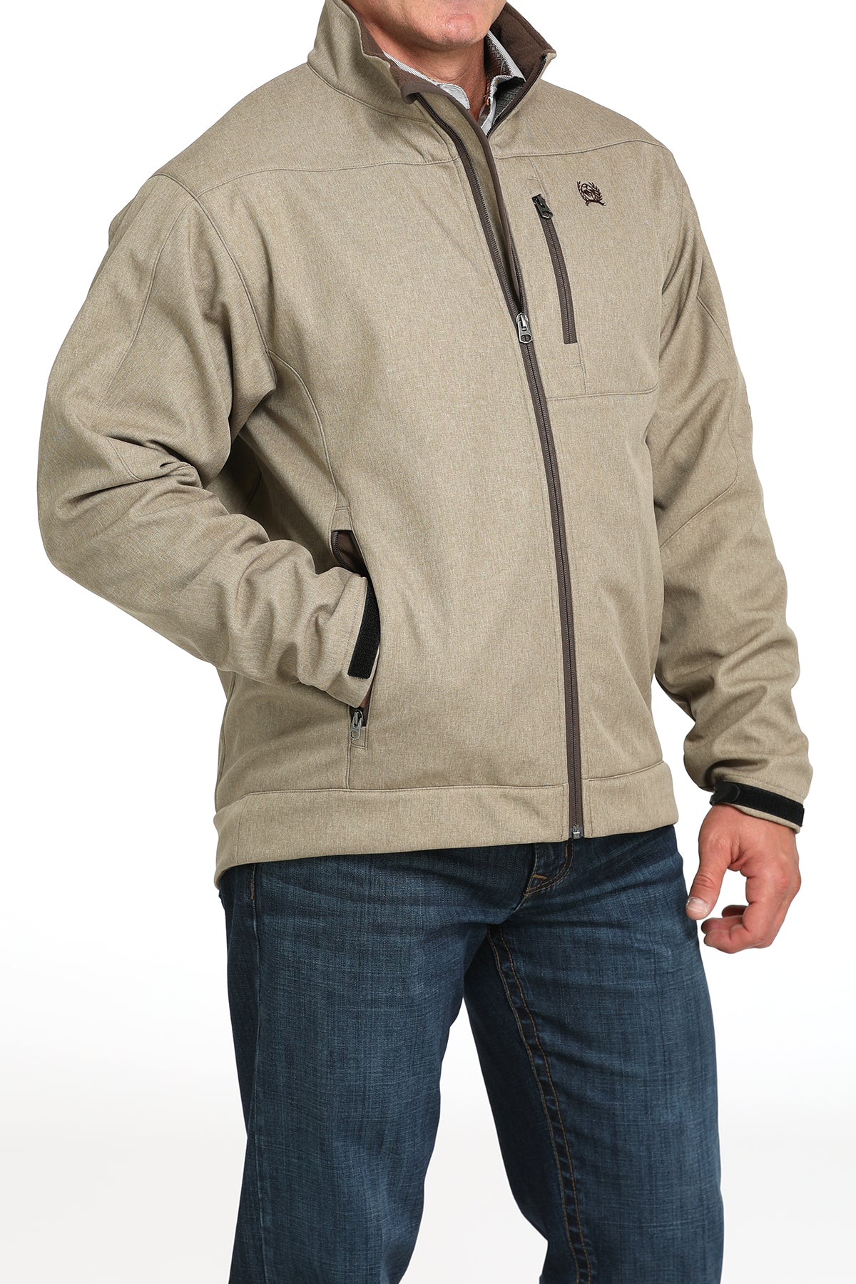 Man wearing a khaki jacket and jeans on a white background