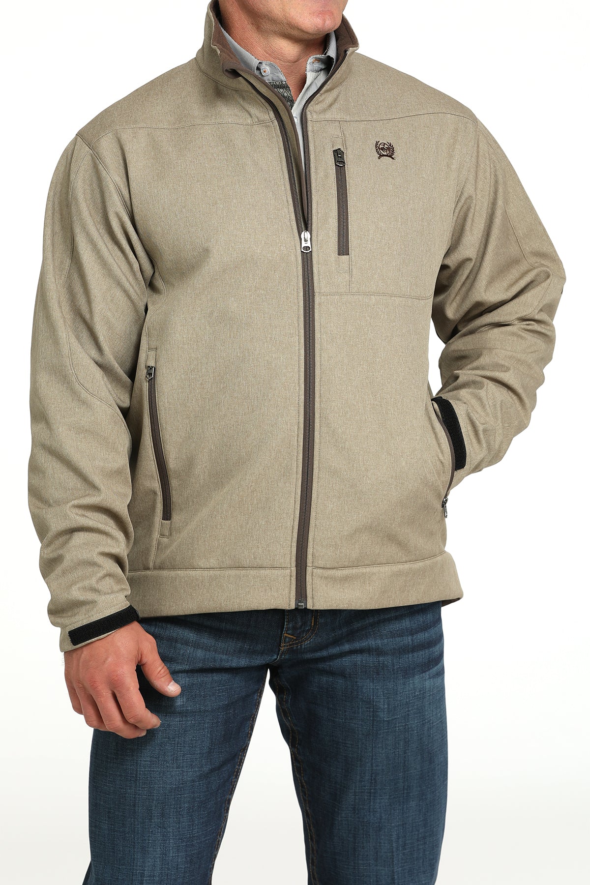Man wearing a khaki jacket and jeans on a white background