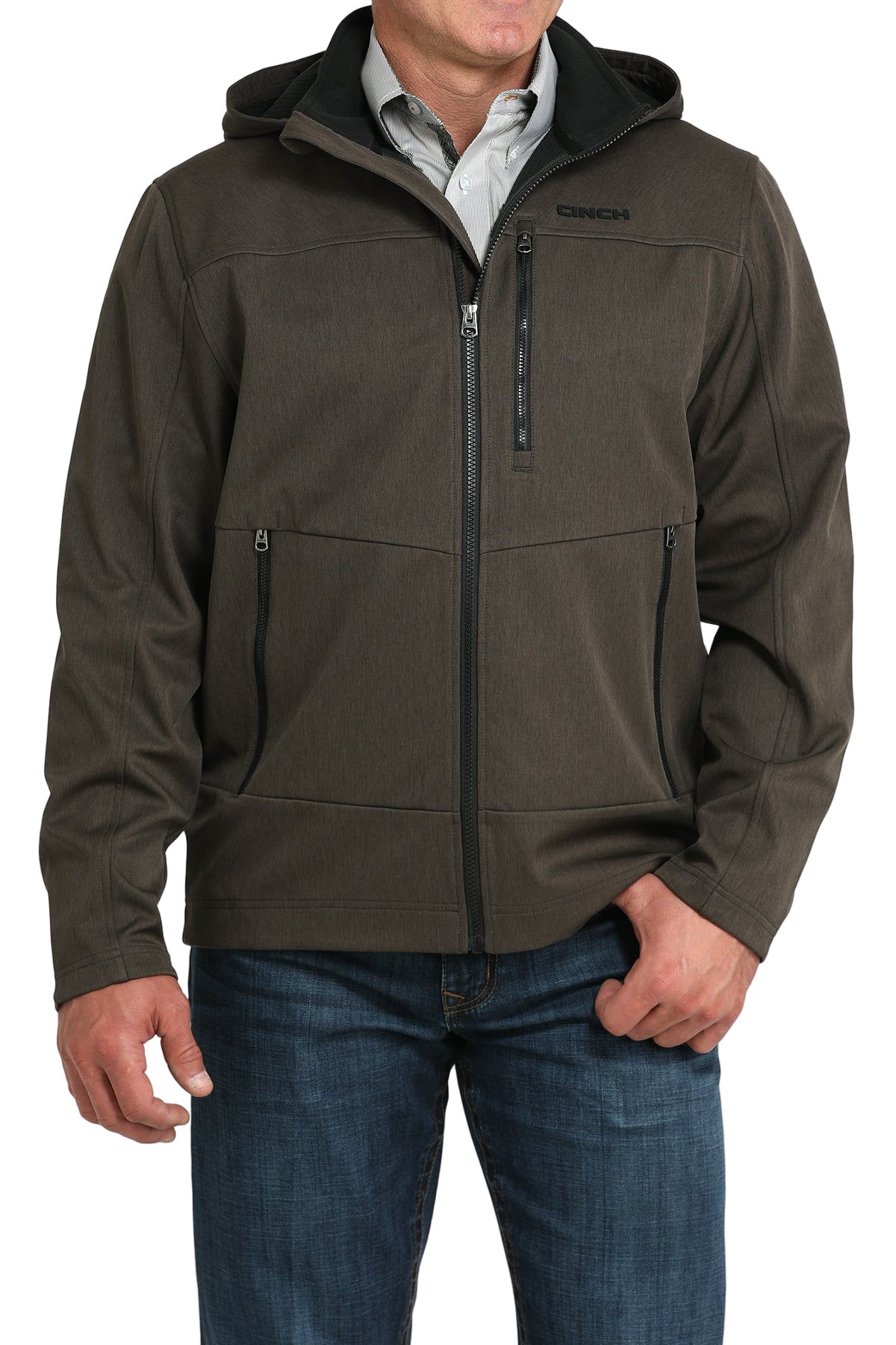 Man wearing a brown hooded softshell jacket paired with blue jeans