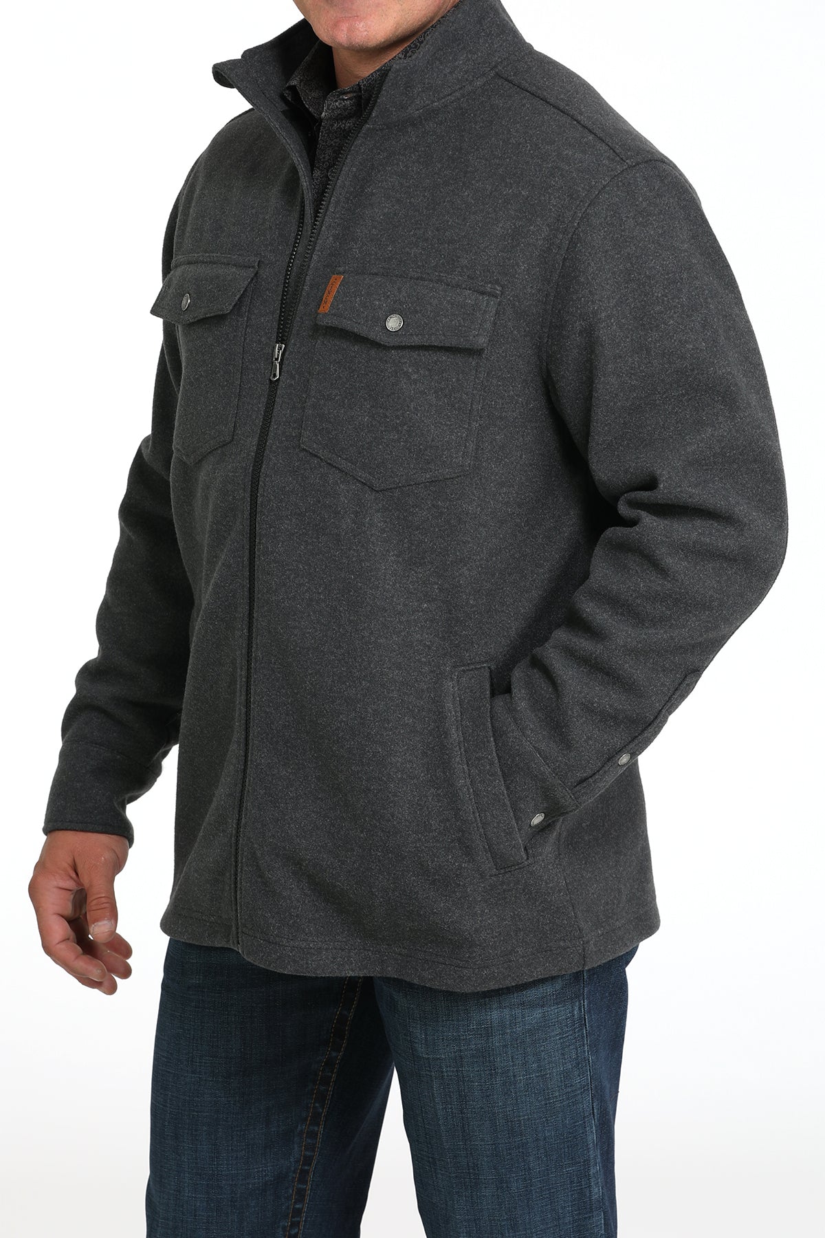 Man wearing a gray jacket and jeans