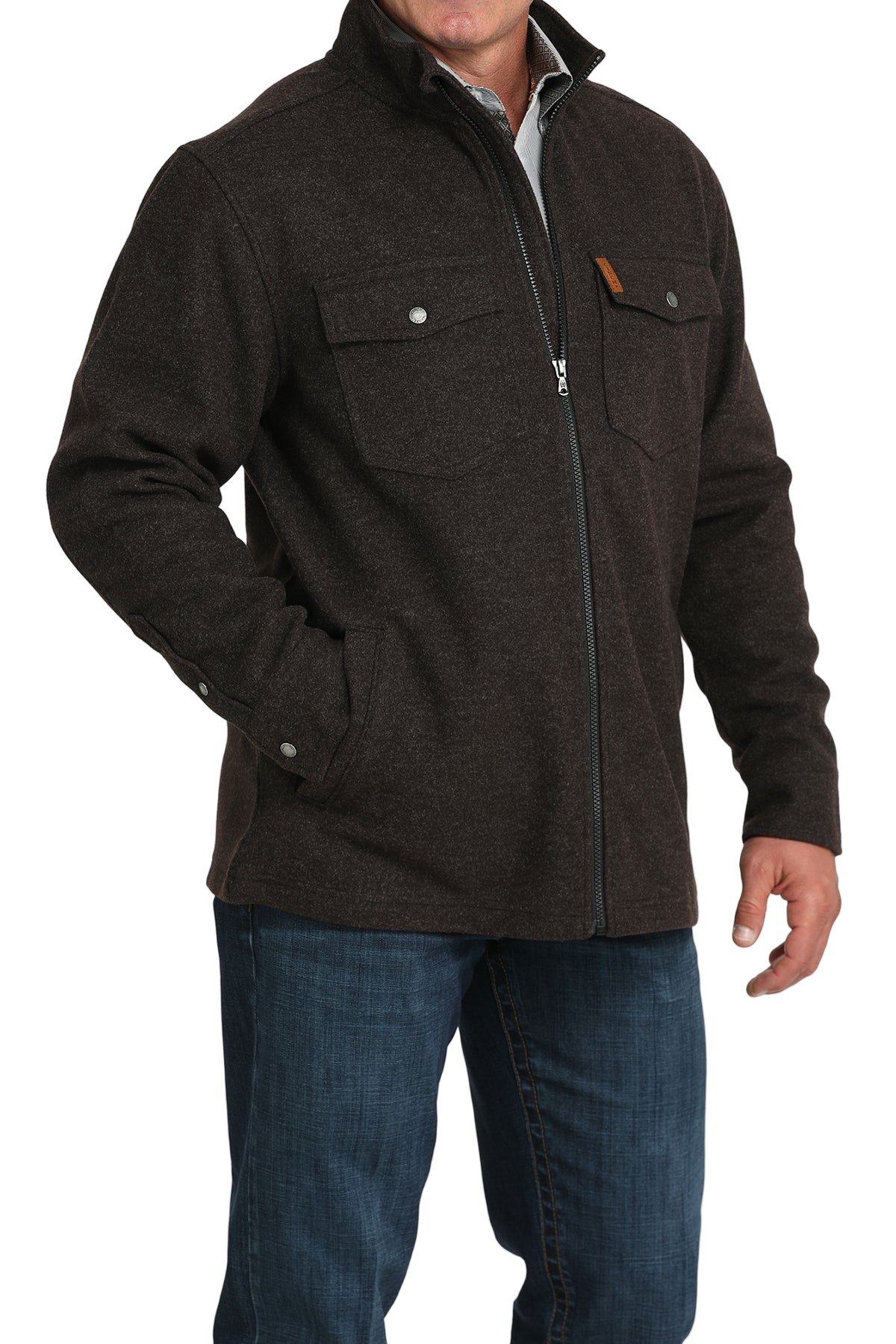 Man wearing a dark brown zip-front jacket with flap chest pockets, paired with blue jeans