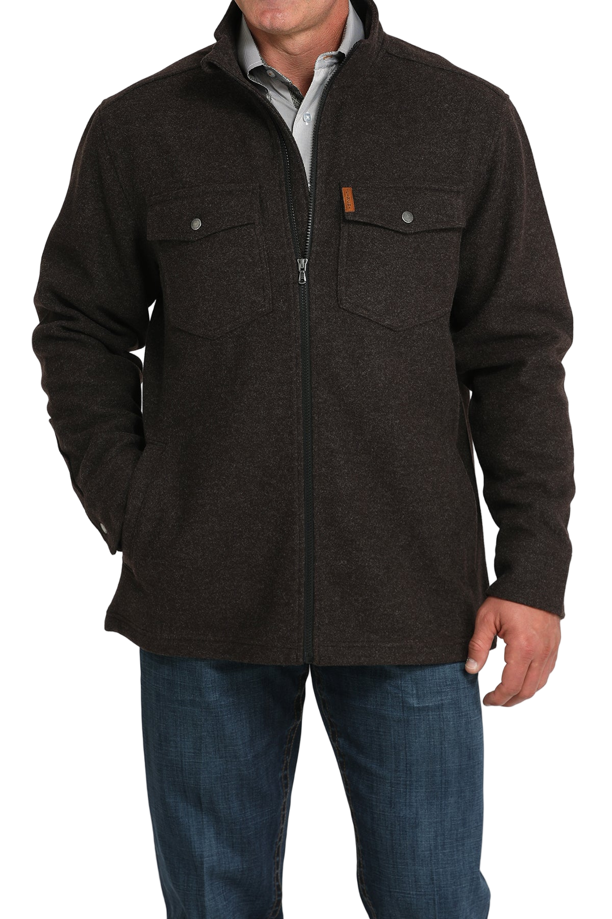 Man wearing a dark brown zip-front jacket with flap chest pockets, paired with blue jeans