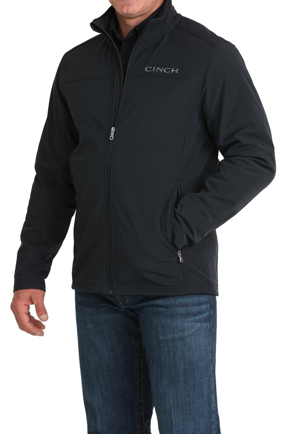 Man wearing a black CINCH jacket with a front zipper, paired with blue jeans