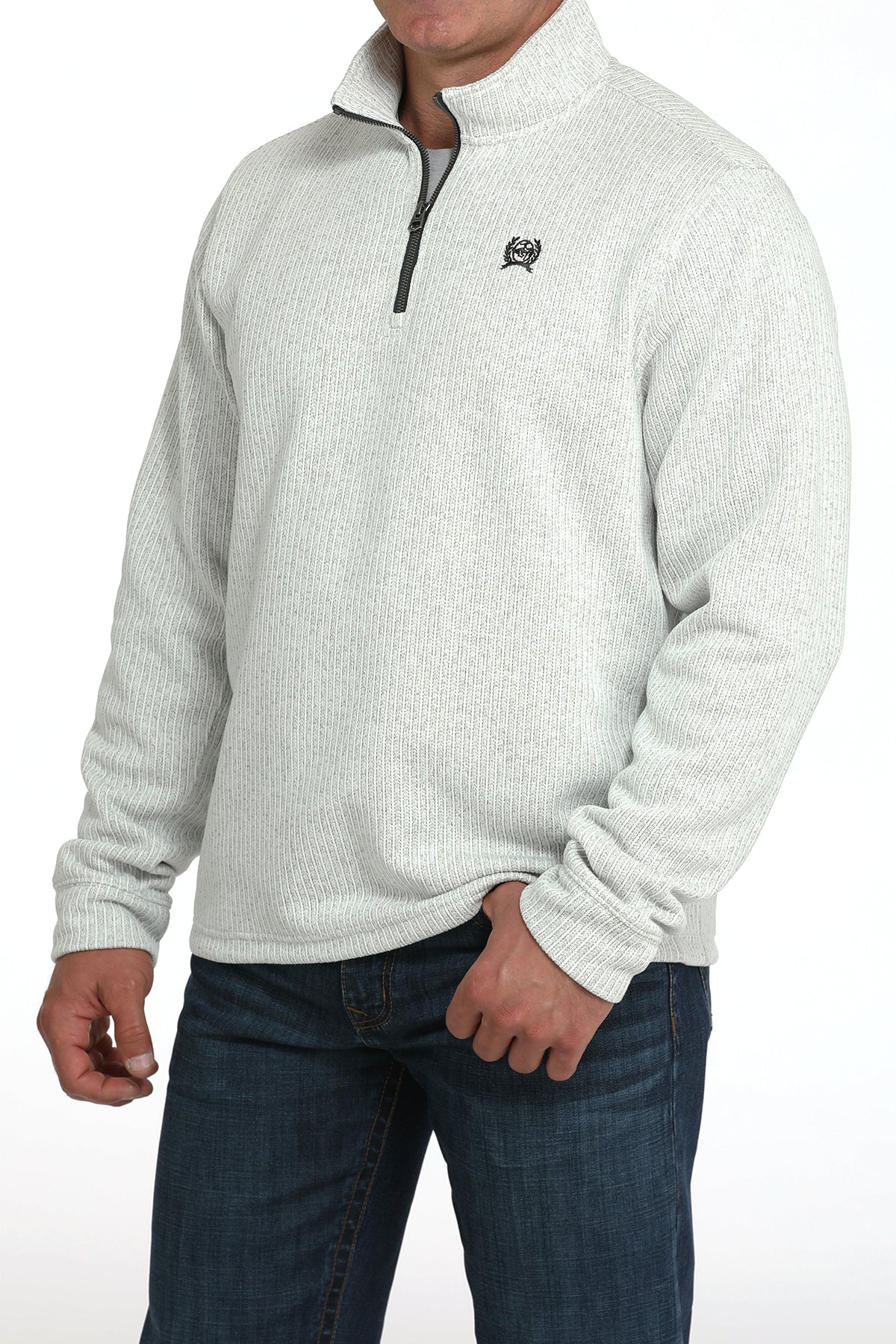 Man wearing a light gray 1/4 zip jacket with jeans