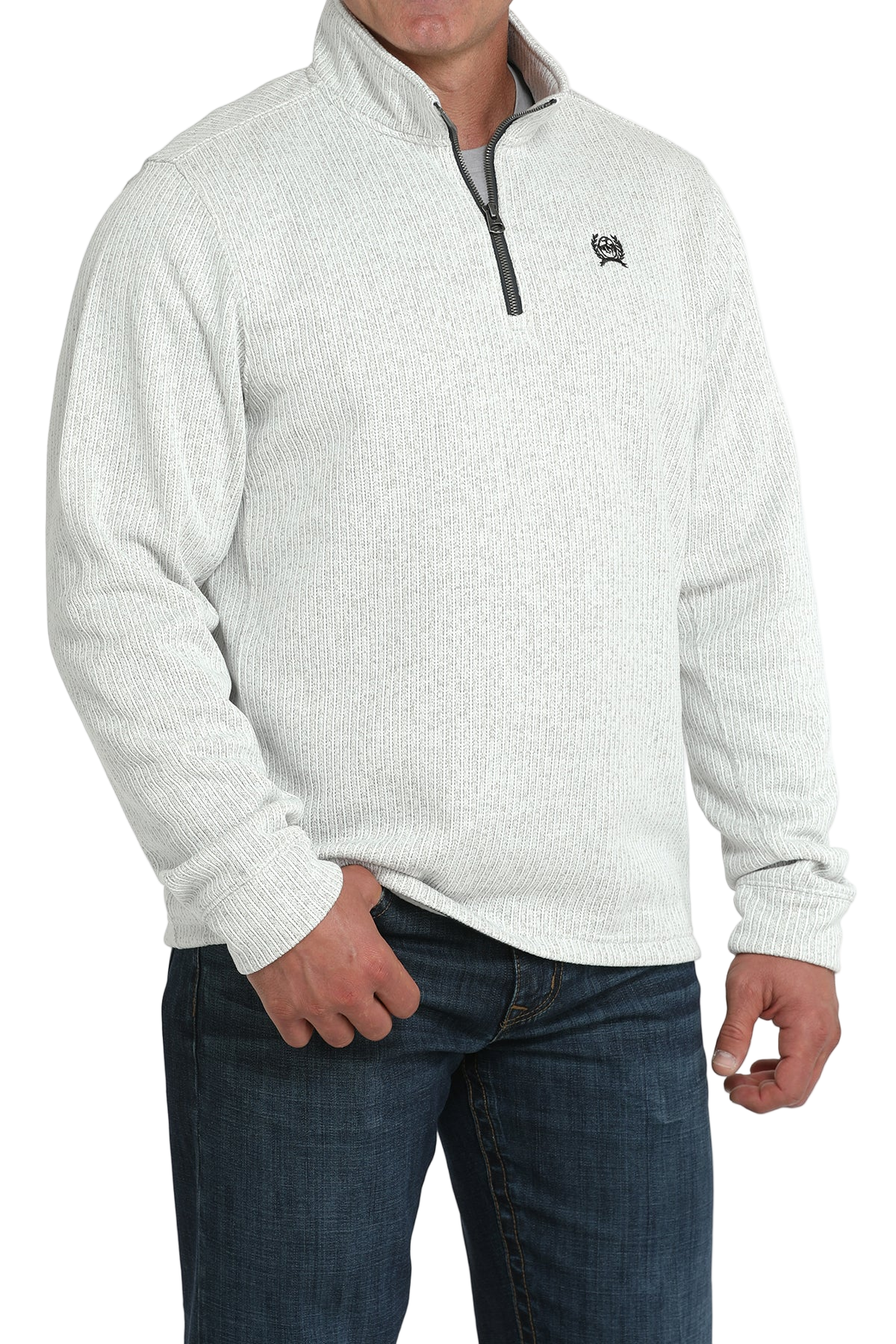 Man wearing a light gray textured quarter-zip pullover with dark jeans