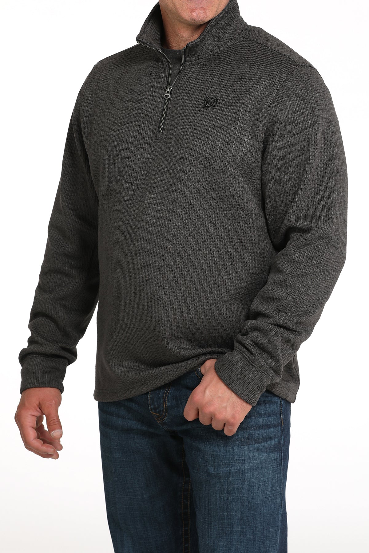 Man wearing a gray 1/4 zip jacket with jeans