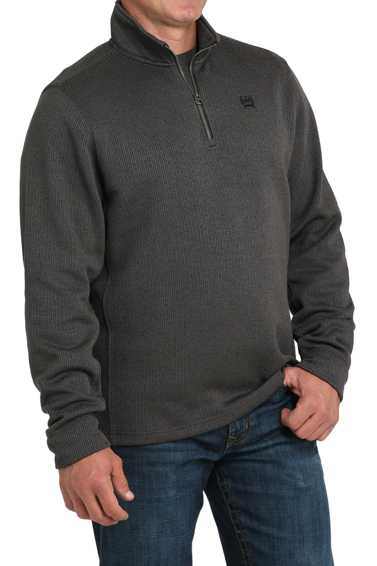 Man wearing a gray quarter-zip sweater and blue jeans on a white background