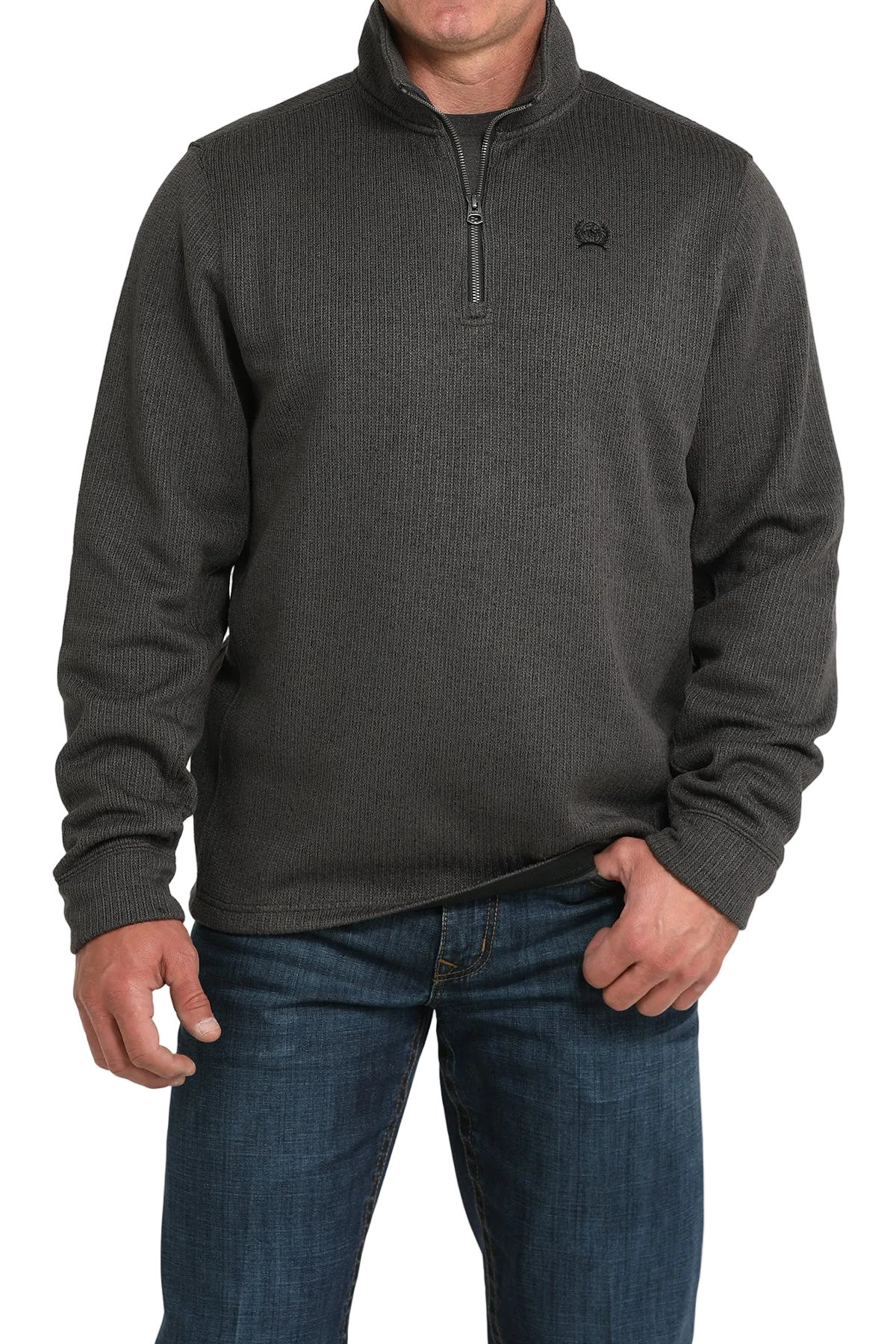 Man wearing a dark gray quarter-zip sweater and blue jeans on a white background