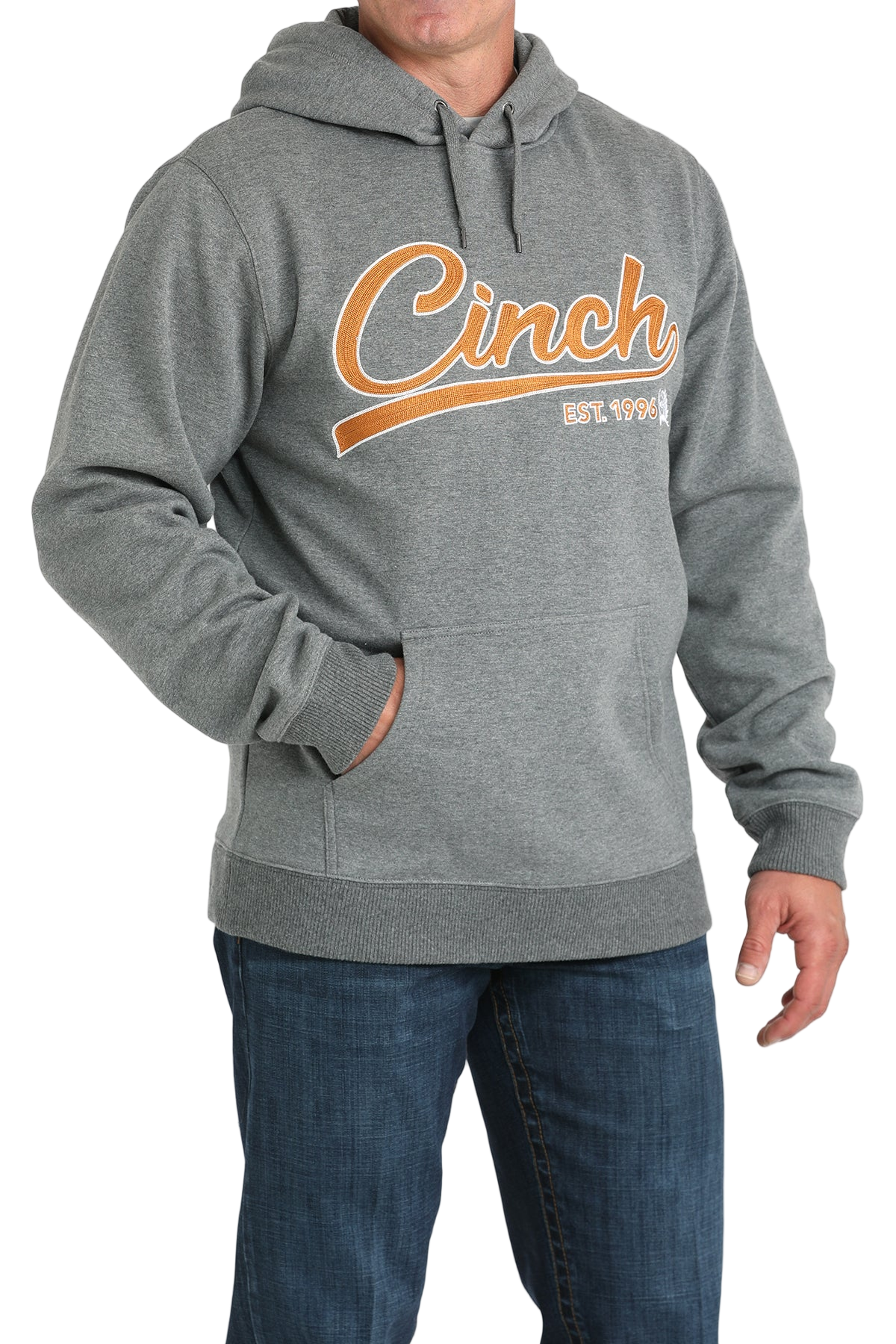 Man wearing a gray hoodie with a 'Cinch' logo written in orange lettering across the front, paired with jeans on a transparent background