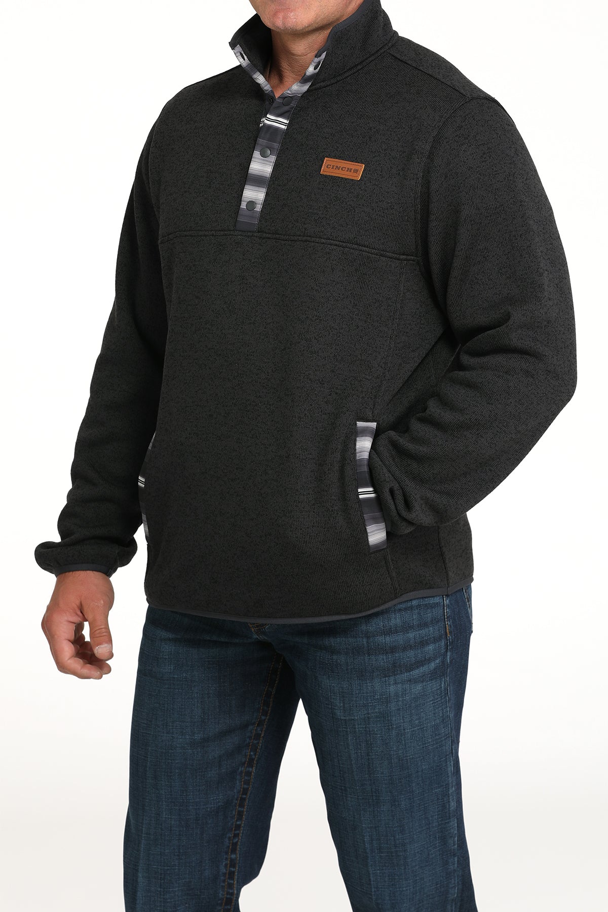 Man wearing a dark gray pullover jacket with jeans