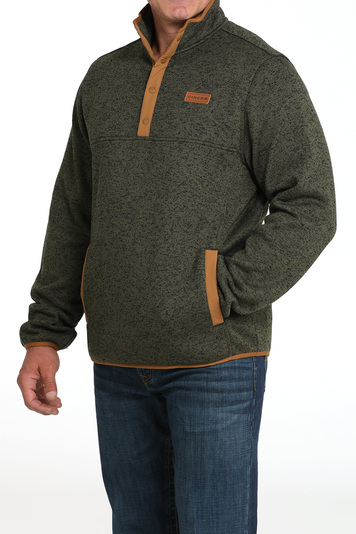 Man wearing a green pullover jacket with jeans