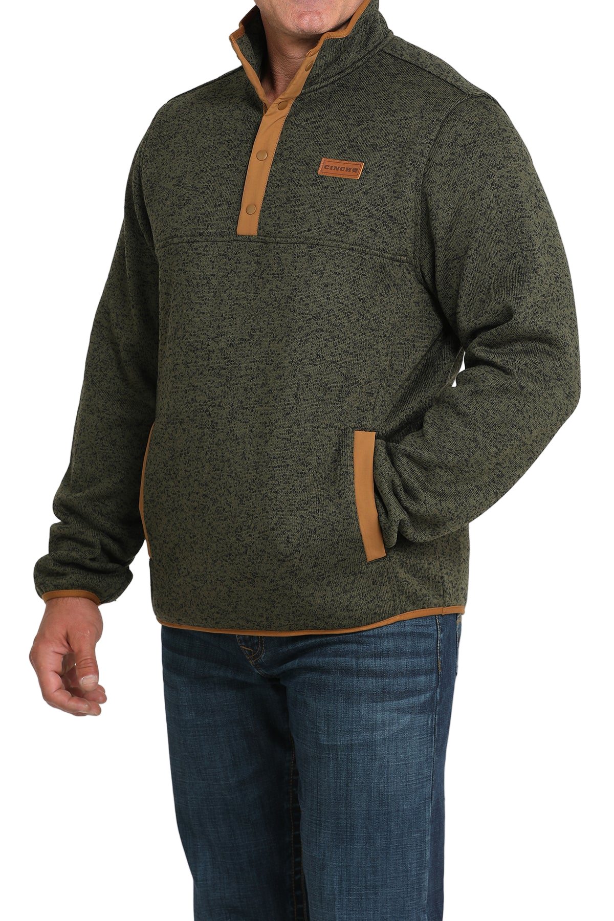 Man wearing a green textured pullover with a snap-button placket, stand-up collar, and front hand pockets, paired with blue jeans