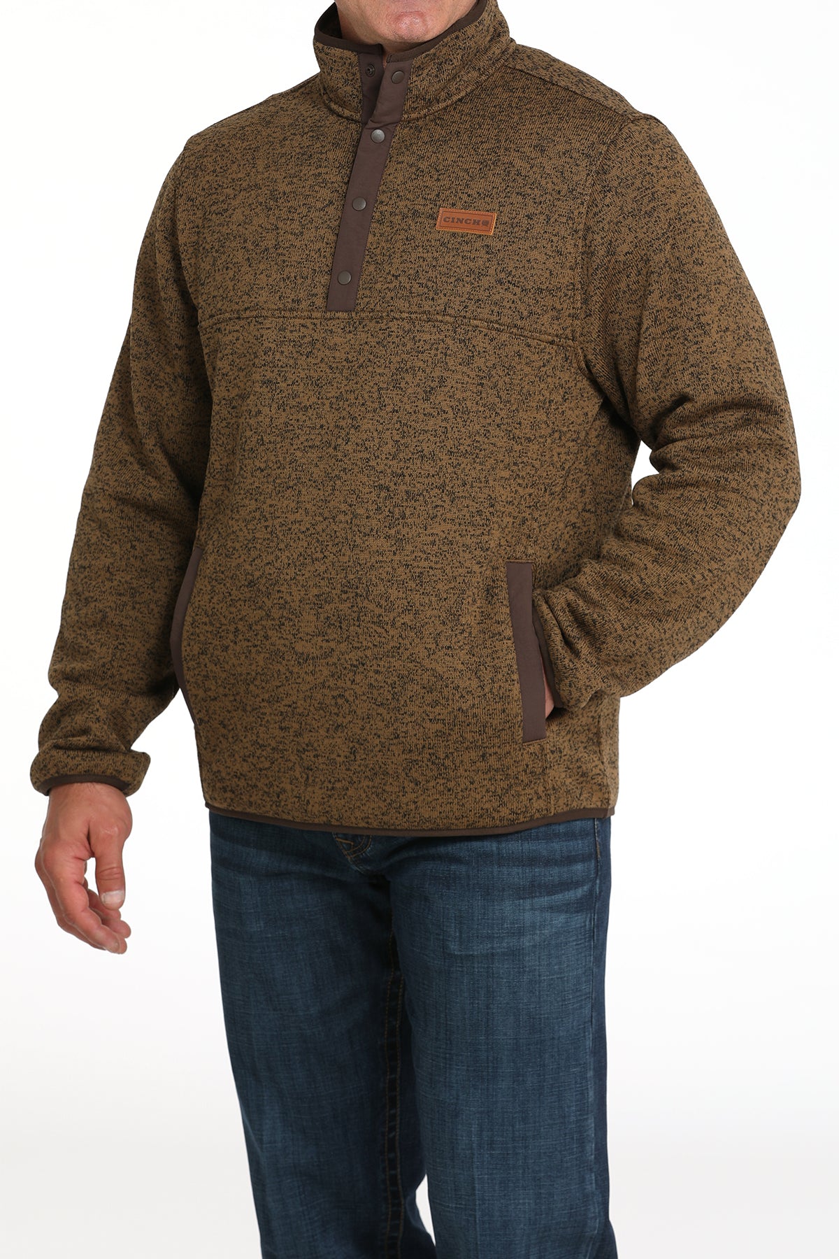 Man wearing a khaki pullover jacket with jeans