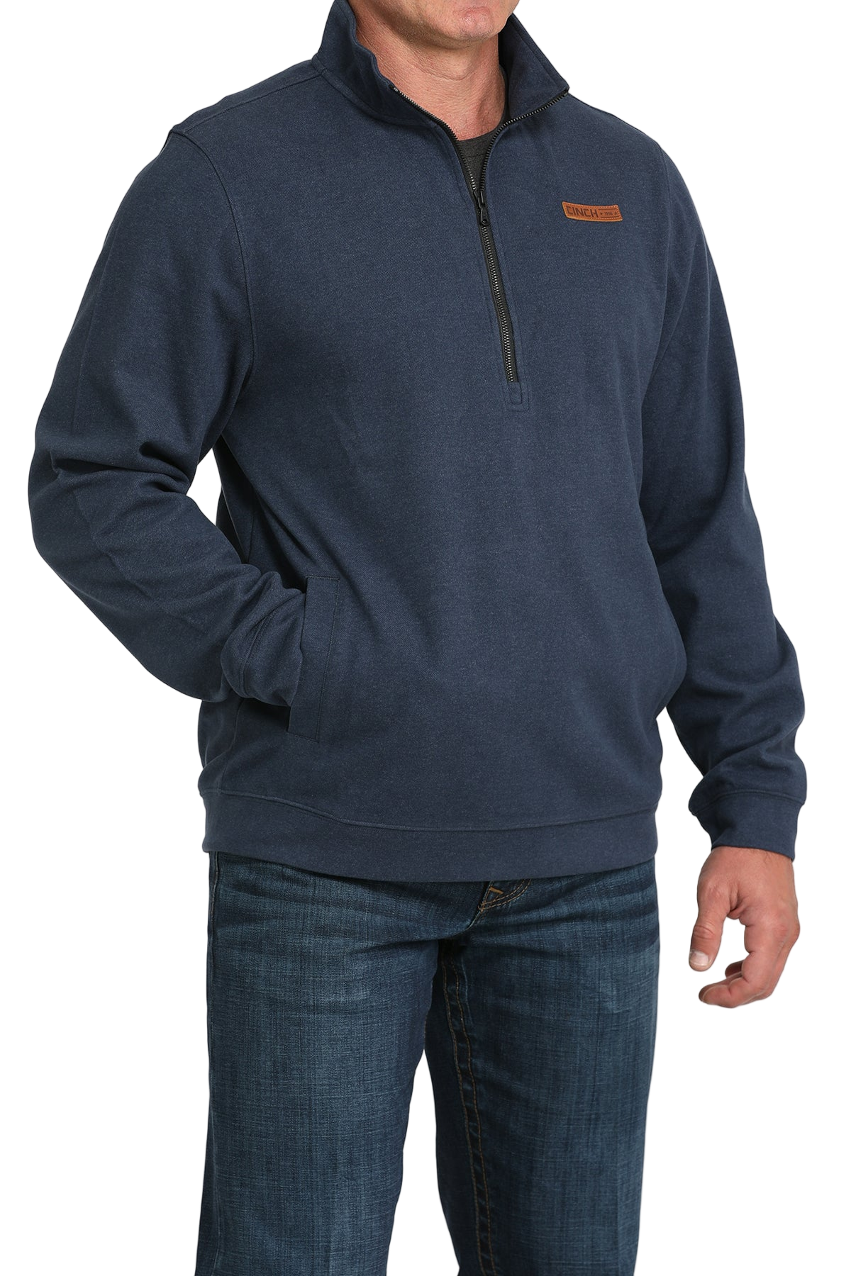 Man wearing a blue pullover with a small logo on a white background