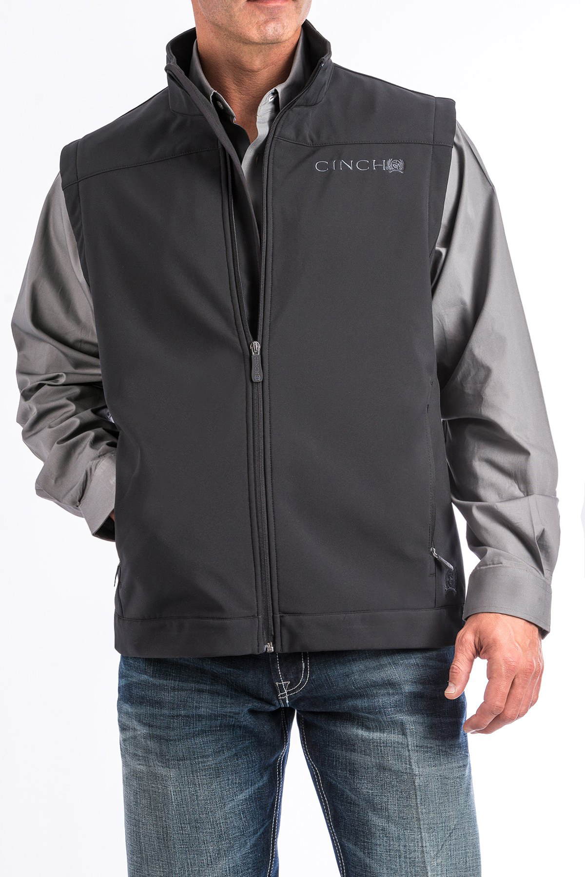 Man wearing a 'CINCH' vest with an undershirt and jeans