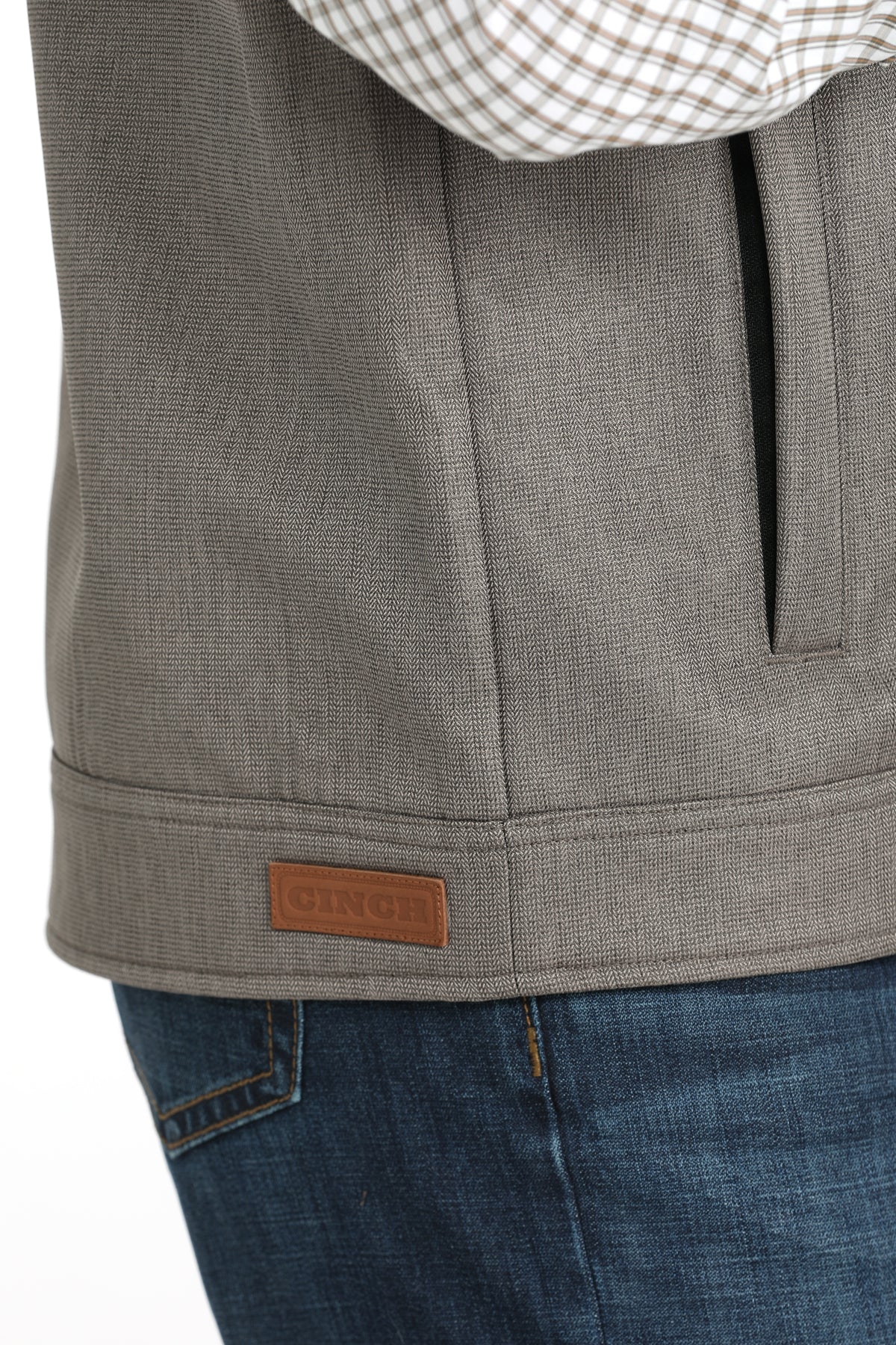 Close-up of a brown vest and jeans