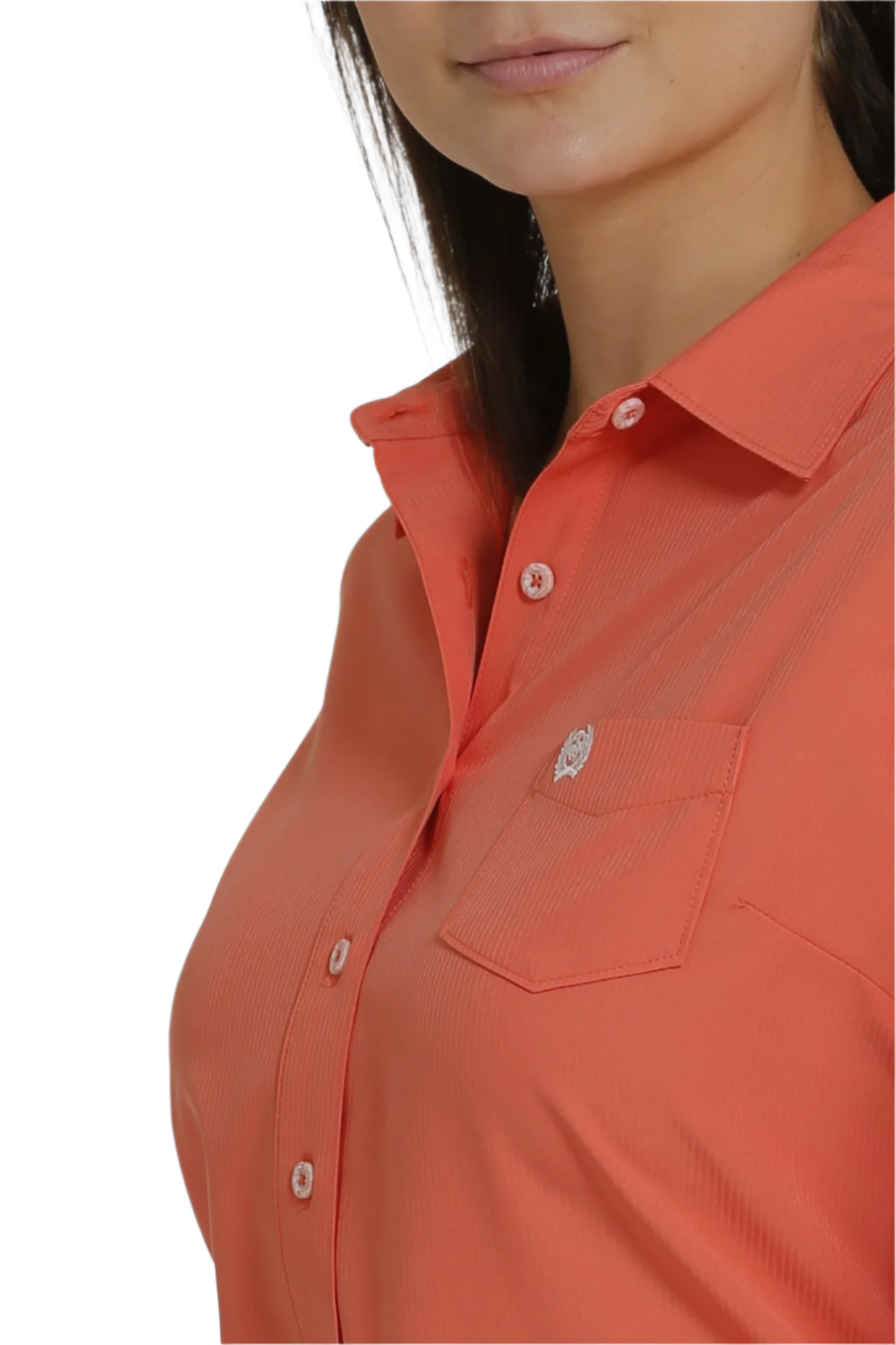 Close-up of a woman wearing a long-sleeve coral Western shirt with a button-down collar