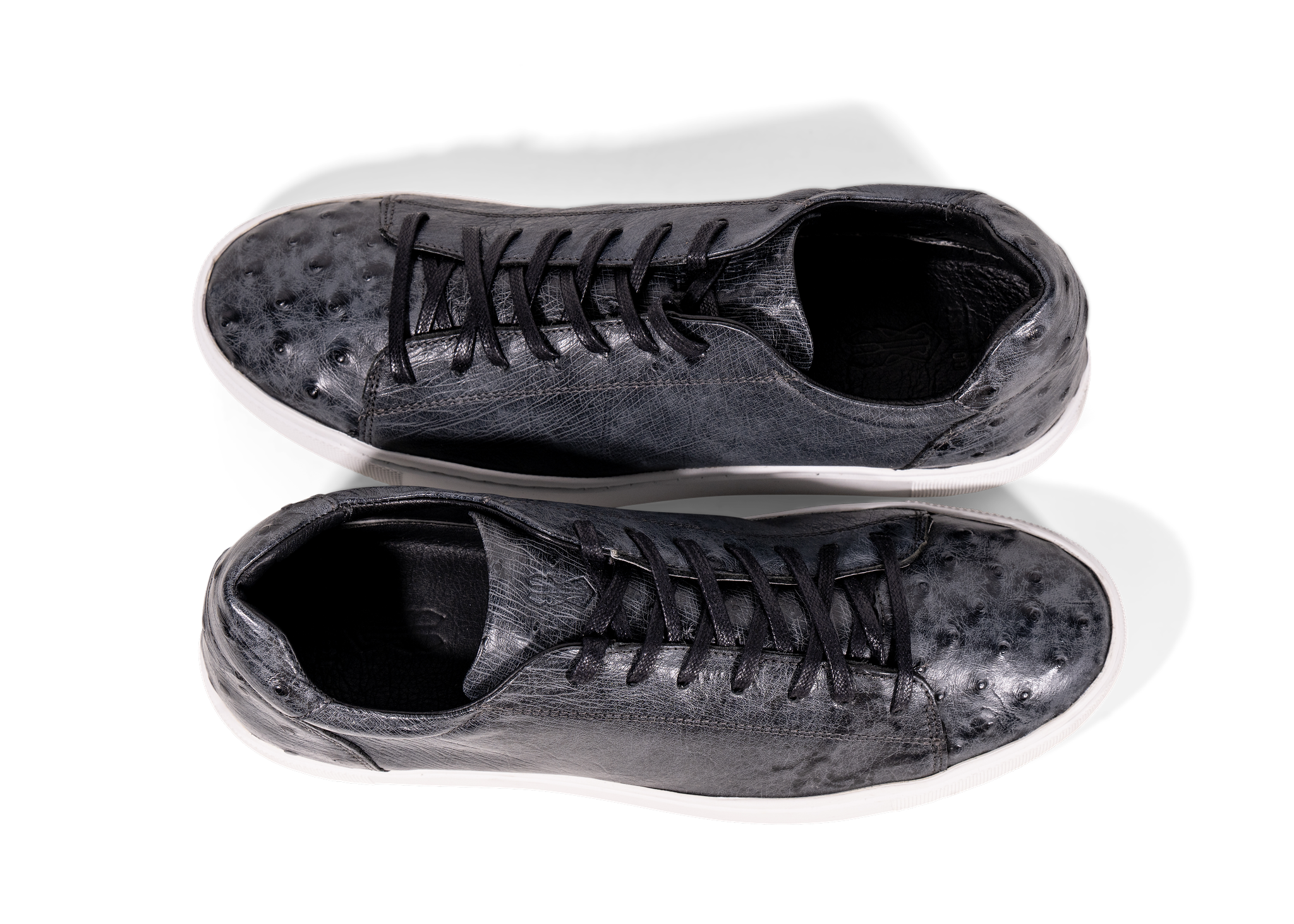 Pair of Go West Supply Navy ostrich leather sneakers on a white background