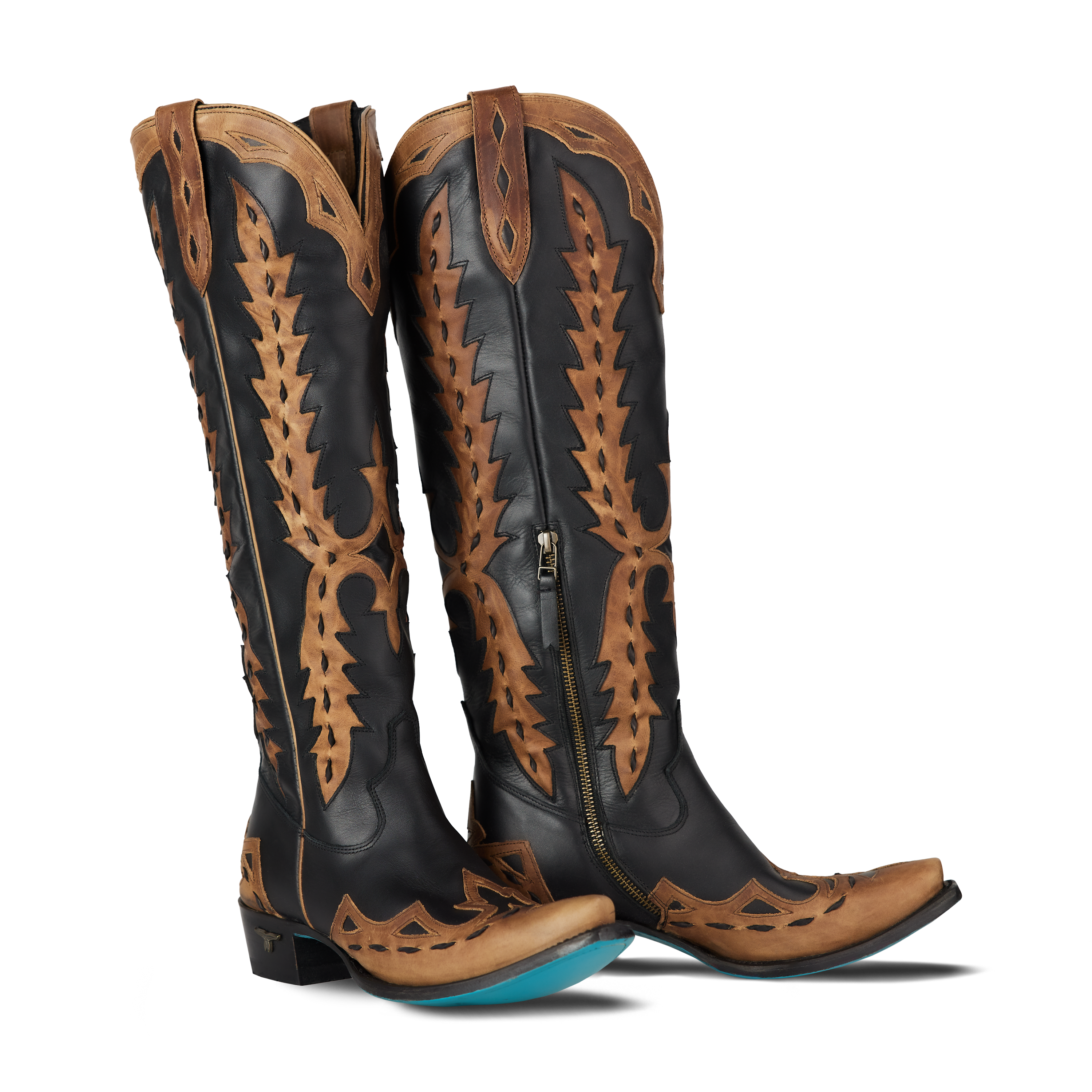 Pair of black and brown cowboy boots with intricate designs on a white background
