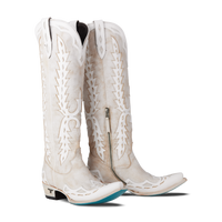 Pair of women’s white knee-high western boots with white stitching and cutout detailing, displayed on a white background