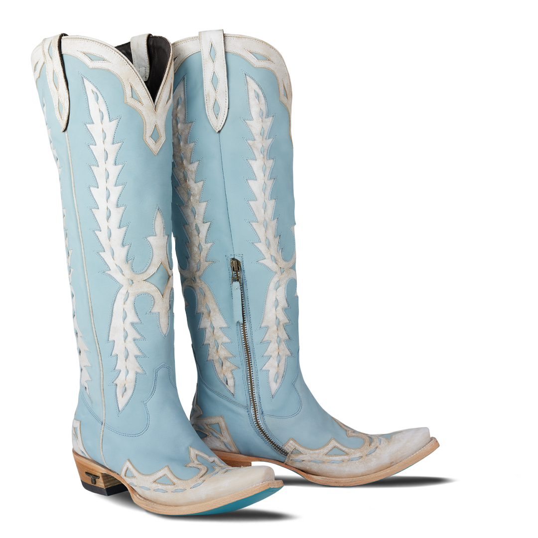 Light blue cowboy boots with white embroidery on a white background