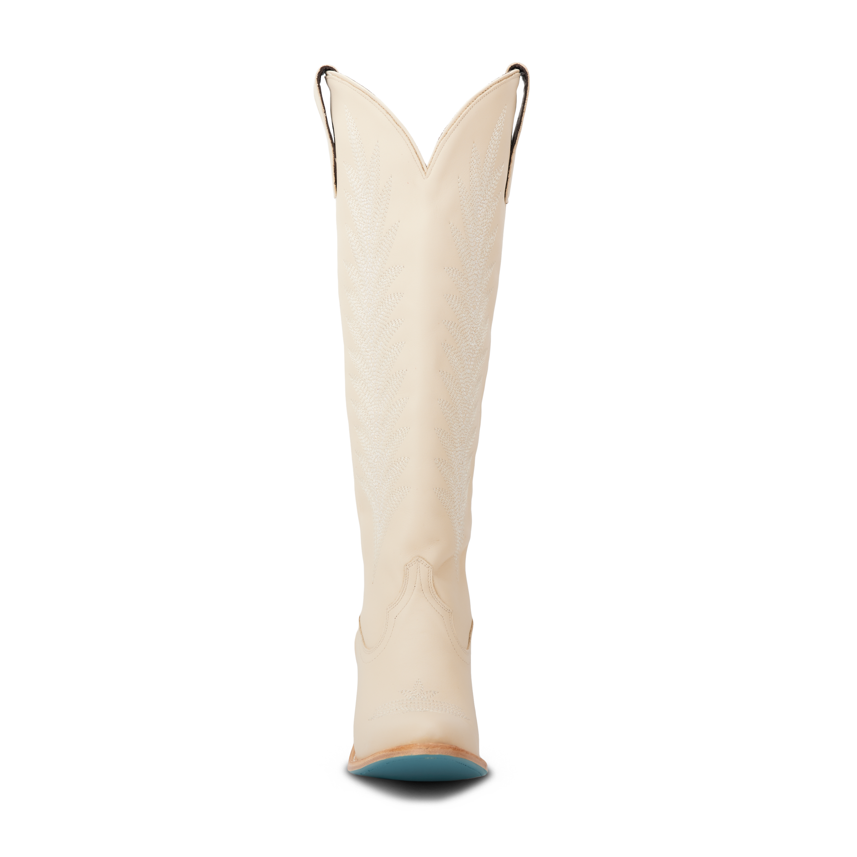 Front view of a tall cream colored cowboy boot with a V-cut top and pull straps, featuring intricate stitching along the shaft and a turquoise sole peeking out from the toe